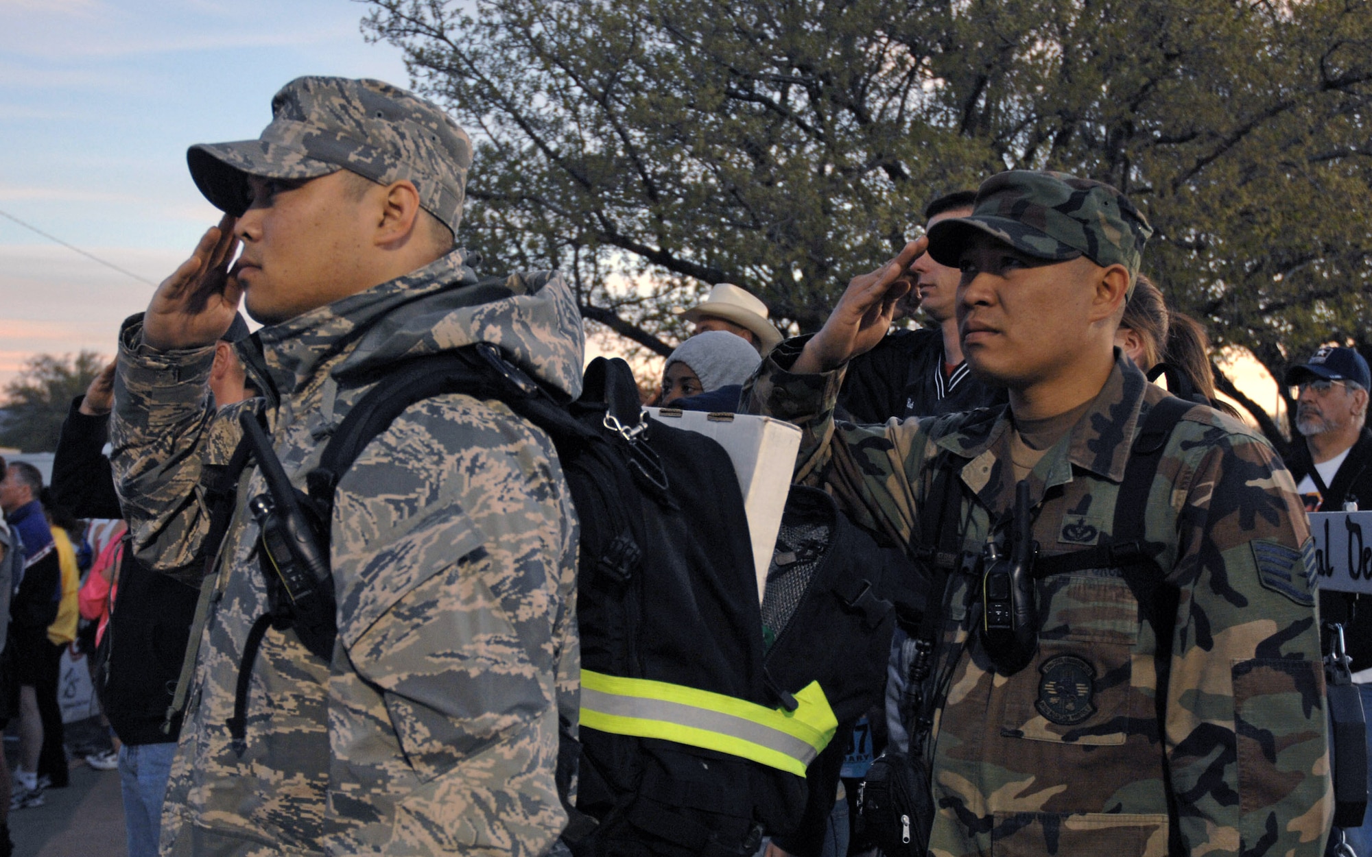 Staff Sgts. Angelito Cooper (left) and Rhallete Javier salute the flag during opening ceremonies of the 19th Annual Bataan Memorial Death March March 30 at White Sands Missile Range, N.M. More than 4,400 runners and marchers participated in the 26.2 or 15-mile run/walk on March 30. Sergeant Cooper is assigned to the 27th Special Operations Logistics Readiness Squadron, and Sergeant Javier is from the 27th Special Operations Civil Engineer Squadron, both from Cannon Air Force Base, N.M. (U.S. Air Force photo/Airman 1st Class Evelyn Chavez) 
