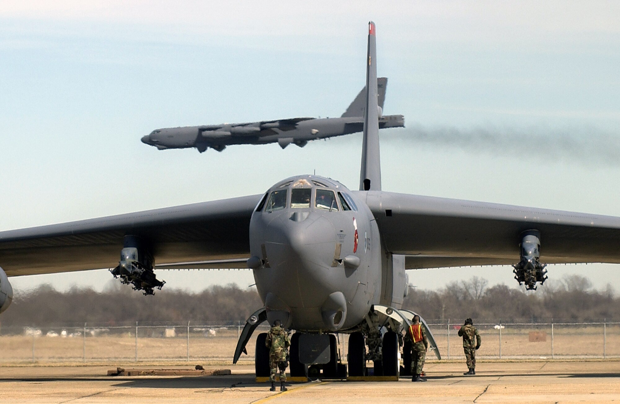 A B-52 prepares for departure as another B-52 arrives. The B-52 is capable of flying 8,800 miles without refueling and can carry a weapons load of up to 70,000 pounds. (U.S. Air Force photo/Tech. Sgt. Robert Horstman)
