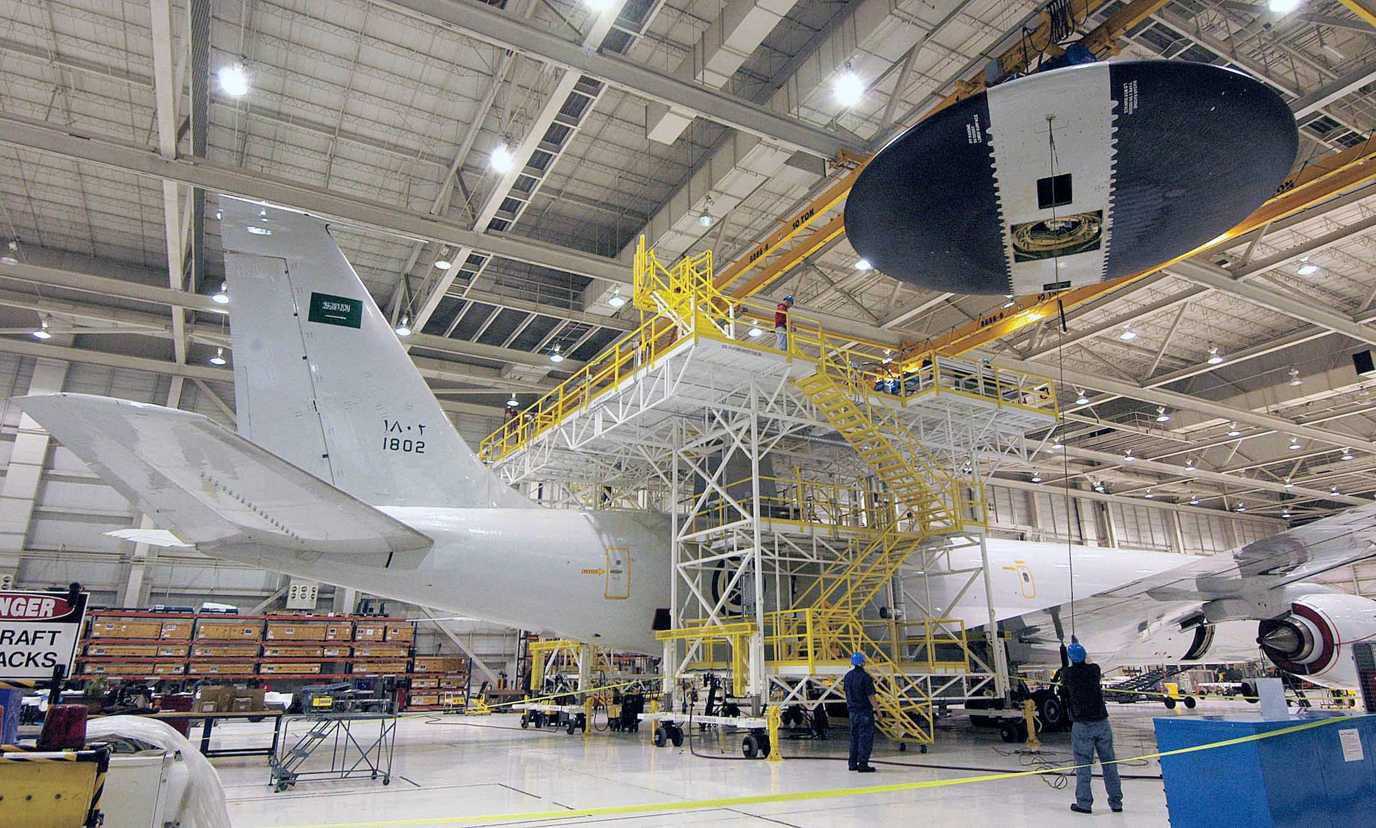 Maintainers ease the 30-foot-diameter rotodome onto a Royal Saudi air force E-3 March 10 at Tinker Air Force Base, Okla. Mechanics in the 566th Aircraft Maintenance Squadron lowered the rotodome to a work stand to replace the antenna pedestal turntable. (U.S. Air Force photo/Margo Wright) 
