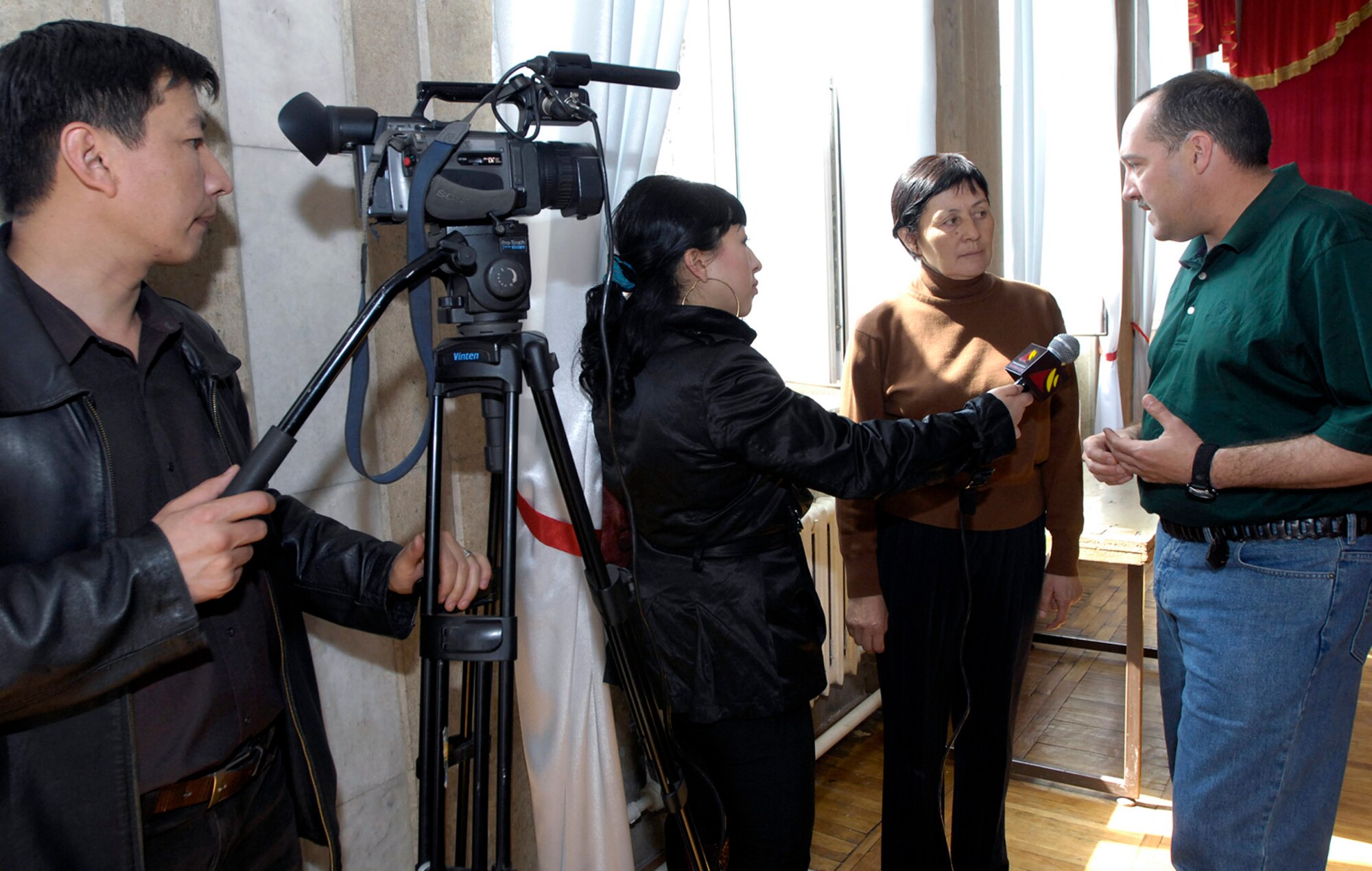 Master Sgt. Dean Smith is interviewed by a Bishkek television station reporter March 26 at the Bishkek College of Music in Kyrgyzstan. Sergeant Smith is the the operations manager for the U.S. Air Forces Central Band Hot Brass. The band performed at the Bishkek College of Music as well other locations off-base during their six-day trip to Kyrgyzstan. (U.S. Air Force photo/Senior Airman Tabitha Kuykendall) 
