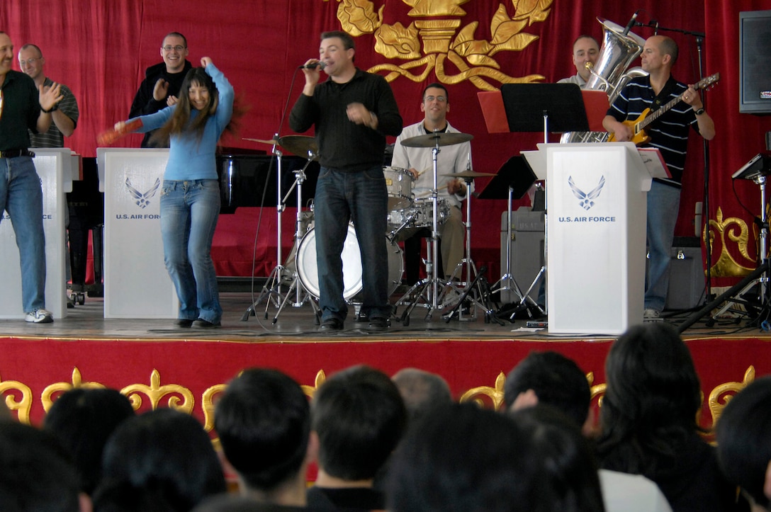 Gulia Aidaralieva plays the tambourine with the U.S. Air Forces Central Band Hot Brass March 26 at the Bishkek College of Music in Kyrgyzstan. The Air Force pop band performed at the Bishkek College of Music as well other locations off-base during their six-day trip to Kyrgyzstan. Miss Aidaralieva is a student of the Bishkek College of Music in Kyrgyzstan. (U.S. Air Force photo/Senior Airman Tabitha Kuykendall) 