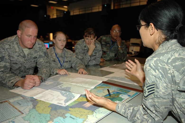Staff Sgt. Corin Lewis, right, 612th Air Operations Center, intelligence/reconnaissance division targets team, trains members on proper mapping practices here March 27. (U.S. Air Force photo by Airman 1st Class Noah R. Johnson)