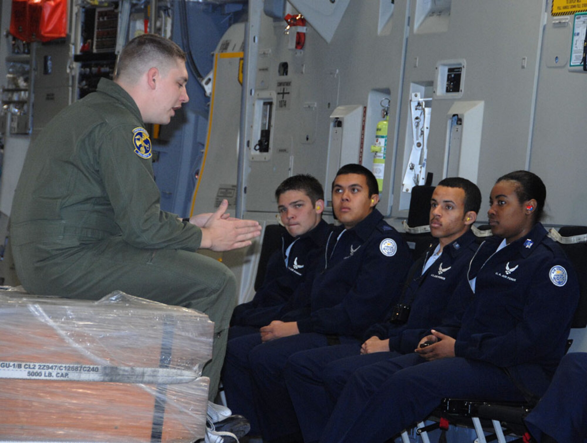 TRAVIS AIR FORCE BASE, Calif. -- All ears: While waiting for the aircraft preflight inspection to be finished up, Staff Sgt. Charles Cummings, loadmaster for the 301st Airlift Squadron, Travis Air Force Base, passes the time answering questions for some very curious Reserve Officers’ Training Corps students anxiously awaiting their orientation flight on the newest aircraft in the Air Force inventory, the C-17 Globemaster III. Sergeant Cummings, who himself was a ROTC member, was instrumental in organizing the flight for the four North California high schools who attended: Vanden High School, Fairfield; Hiram Johnson High School, Sacramento; Armijo High School, Fairfield; and Highlands High School, North Highlands. (U.S. Air Force photo by Master Sgt. Wendy Weidenhamer)