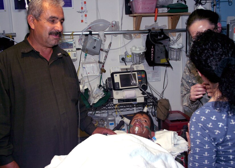 An Iraqi teenager and his father are informed about his treatment through an interpreter at Forward Operating Base Rahmey Jarew, an Iraqi teenager, and his father, Arif Muter Jarew, speak to a doctor about his treatment through an interpreter at Forward Operating Base Warrior in Kirkuk, Iraq, March 27. An improvised explosive device injured the teenager earlier that day. The quick response of Army and Air Force members saved the boy's life. (U.S. Army photo/Staff Sgt. Margaret C. Nelson)