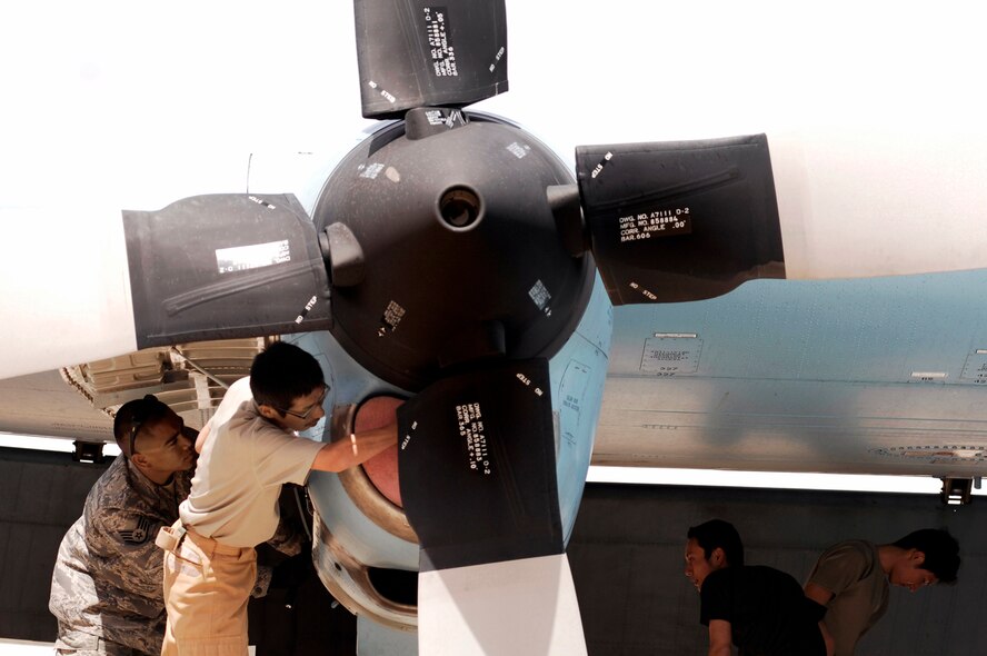 Maintainers from the Japan Air Self-Defense Force Iraq Reconstruction Support Airlift Wing and Staff Sgt. Ray Pontemayor (left) inspect a Japan Air Self-Defense Force C-130 Hercules March 21 at a Southwest Asian air base. Airmen from the U.S., Japanese Air Self-Defense Force and South Korean air force's 58th Airlift Wing participated in a coalition maintenance exchange program allowing maintainers to sharpen their skills, exchange ideas, and promote closer relations among coalition air forces supporting the war on terrorism. Sergeant Pontemayor is a maintainer deployed to the 386th Expeditionary Aircraft Maintenance Squadron. (U.S. Air Force photo/Staff Sgt. Patrick Dixon) 