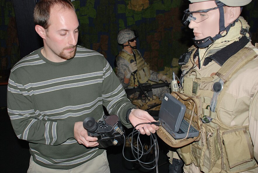 AFRL project engineer Greg Burnett demonstrates the user-friencly cable designed for combat controllers to quickly transfer digital coordinates from a laser rangefinder to a computer in the field. (Photo by Chris Gulliford AFRL/RH)