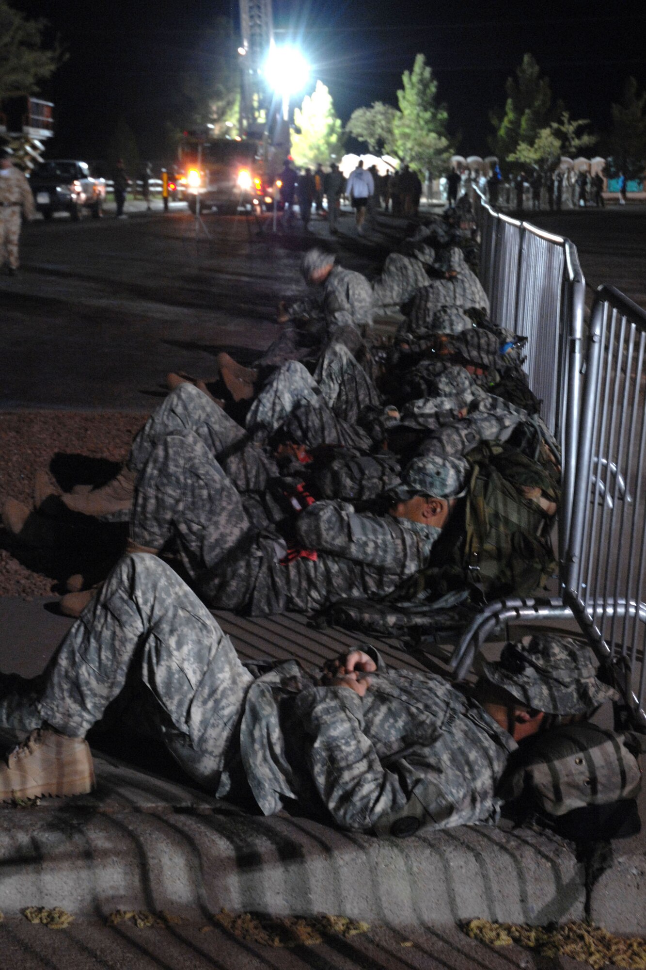 WHITE SANDS MISSILE RANGE, N.M. - Soldiers get some rest before beginning the 19th Annual Bataan Memorial Death March on March 30. More than 4,400 runners and marchers participated in the 26.2 mile or 15-mile run/walk. (U.S. Air Force photo by Airman 1st Class Evelyn Chavez)