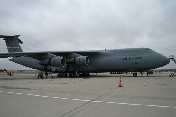A parked C-5 Galaxy operated by the 445th Airlift Wing, Air Force Reserve Command, was struck by lightning March 28, 2008. The lightning strike traveled from the tail section through the aft ramp area of the plane and to the grounding cords before it hit the concrete. (U.S. Air Force photo/Mary Allen)

 
