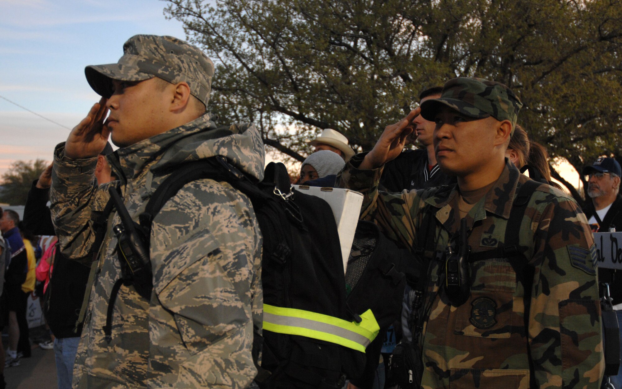 WHITE SANDS MISSILE RANGE, N.M. - Staff Sgts. Angelito Cooper (left), 27th Special Operations Logistics Readiness Squadron, and Rhallete Javier, 27th Special Operations Civil Engineer Squadron, salute the flag during opening ceremonies of the 19th Annual Bataan Memorial Death March. More than 4,400 runners and marchers participated in the 26.2 or 15-mile run/walk on March 30. (U.S. Air Force photo by Airman 1st Class Evelyn Chavez)