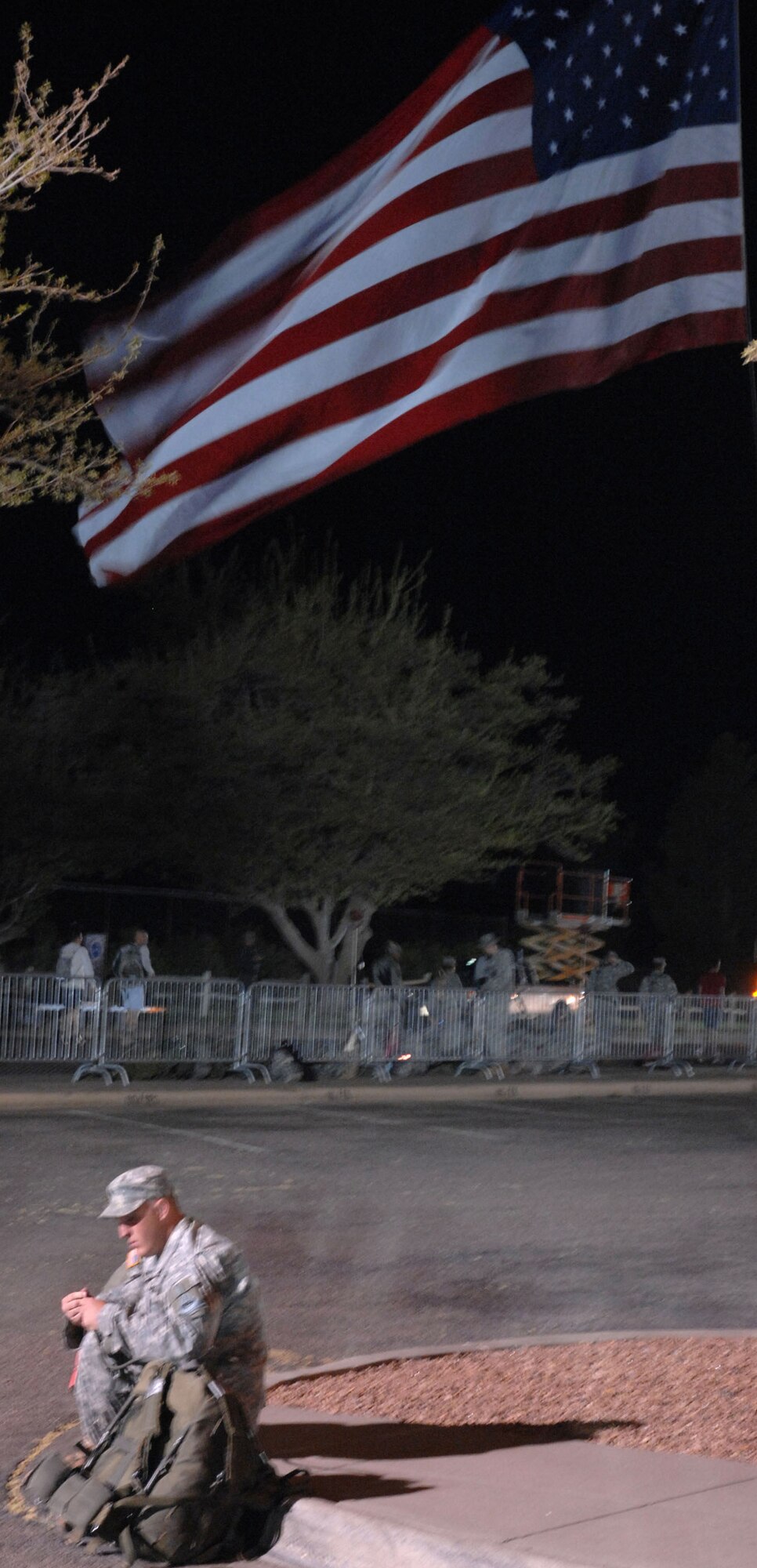 WHITE SANDS MISSILE RANGE, N.M. - A lone Soldier sits on a curb before beginning the 19th Annual Bataan Memorial Death March on March 30. More than 4,400 runners and marchers participated in the 26.2 or 15-mile run/walk. (U.S. Air Force photo by Airman 1st Class Evelyn Chavez)