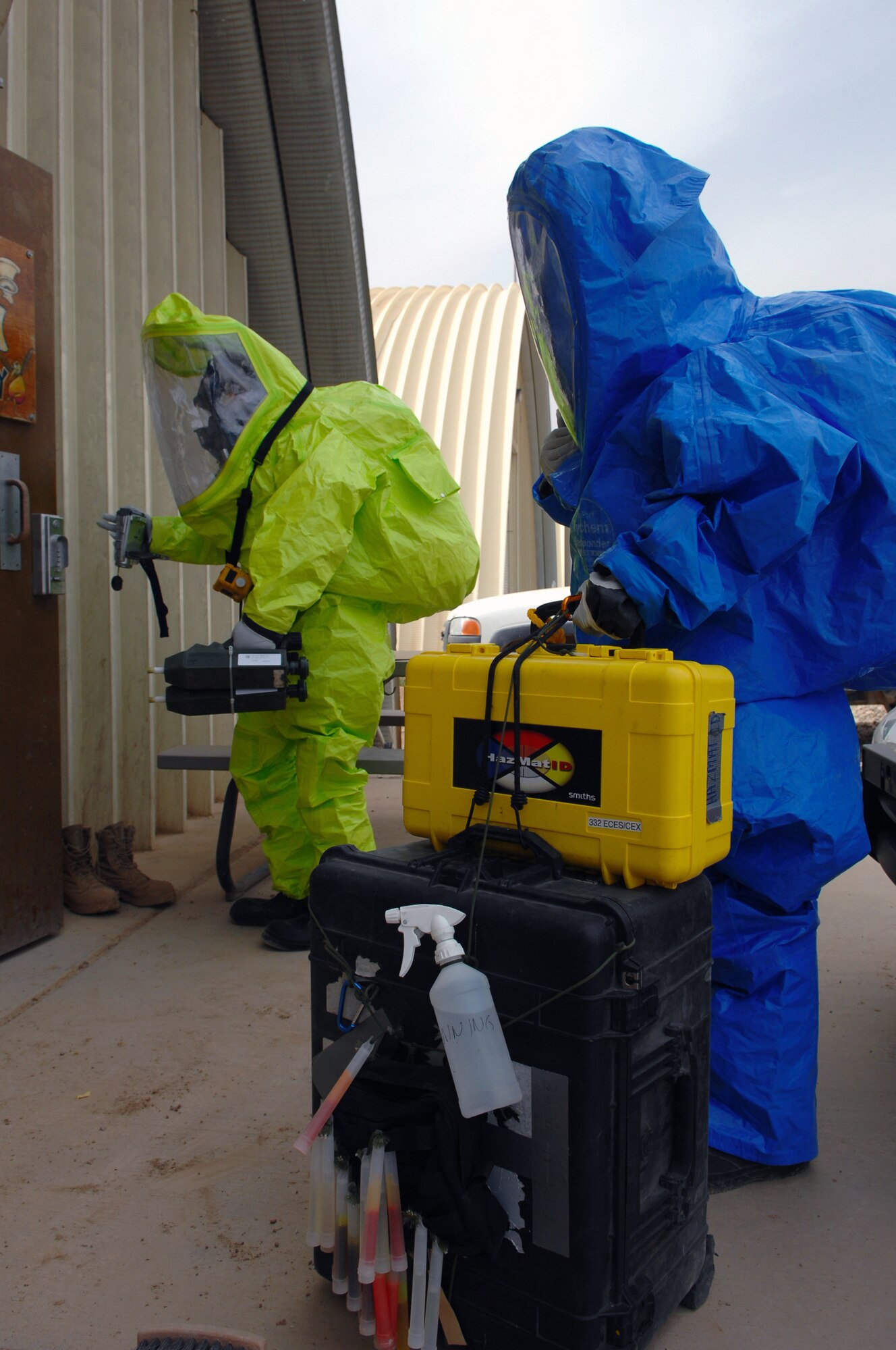 Senior Airmen Krista McVicar and Michael Blair respond to a mysterious substance scenario during a battle drill March 26 at Balad Air Base, Iraq. Emergency managers must identify questionable substances and employ the proper procedures needed to secure the area. Both Airmen are 332nd Expeditionary Civil Engineer Squadron emergency managers. Airman McVicar is deployed from Davis-Monthan Air Force Base, Ariz.; Airman Blair is deployed from McGuire Air Force Base, N.J. (U.S. Air Force photo/Senior Airman Julianne Showalter) 