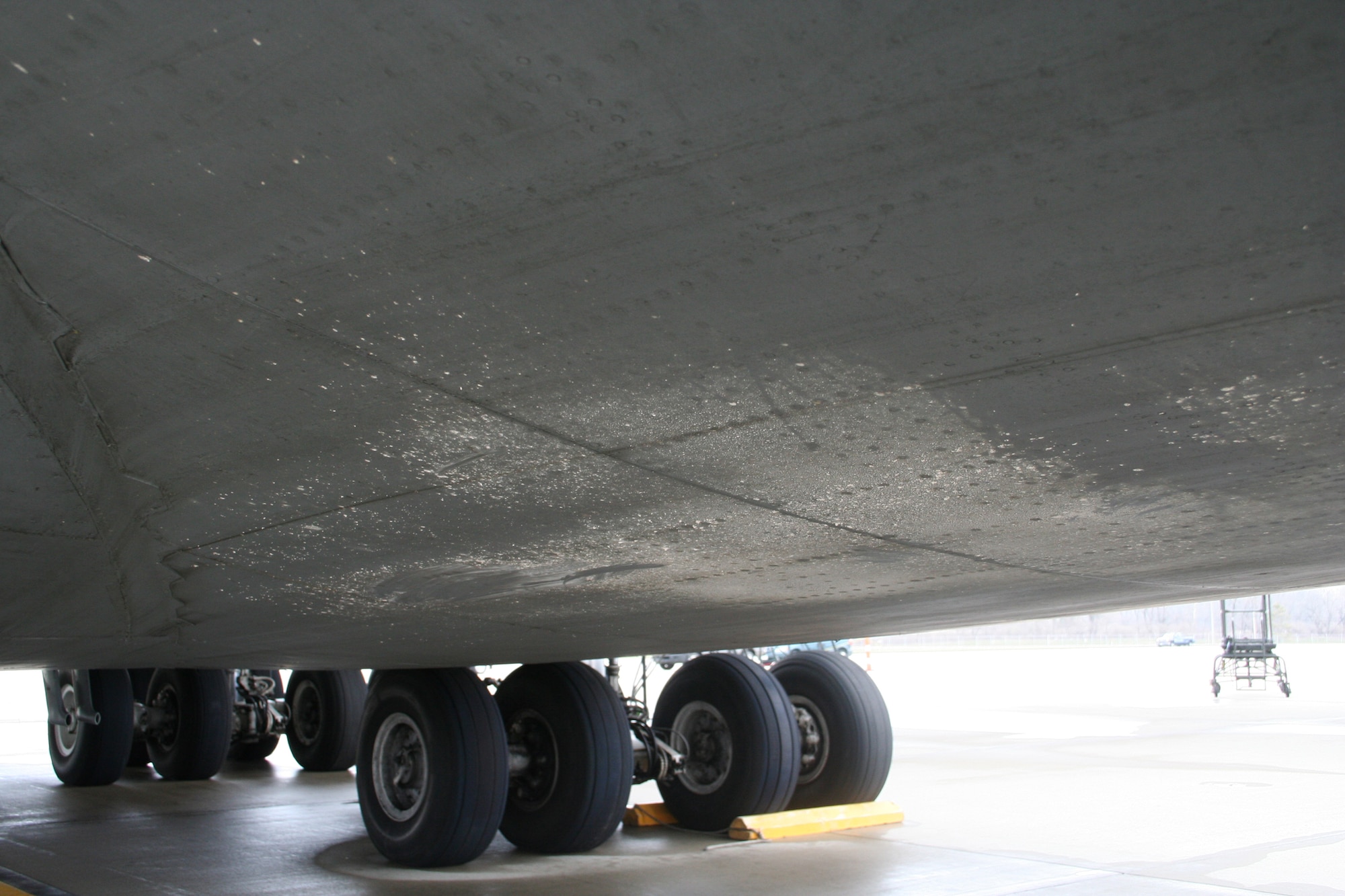 A parked C-5 Galaxy operated by the 445th Airlift Wing, Air Force Reserve Command, was struck by lightning March 28, 2008. The lightning strike traveled from the tail section through the aft ramp area of the plane and to the grounding cords before it hit the concrete.  The concrete splattered onto the aircraft.  (U.S. Air Force photo/Mary Allen)

 
