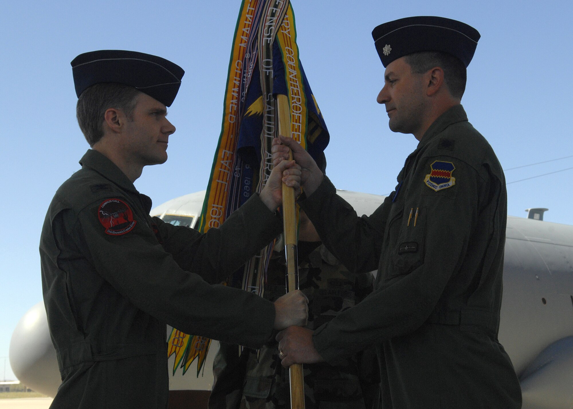 Lt. Col. Marty Reynolds (right) receives the 42nd Electronic Combat Squadron guidon from 55th Electronic Combat Group Commander Col. Mark Haskins during a change-of-command ceremony at Whiskey Ramp here March 29. Colonel Reynolds was already the director of operations at the 42nd ECS before becoming the squadron commander. (U.S. Air Force photo by Senior Airman Jacqueline Hawkins)