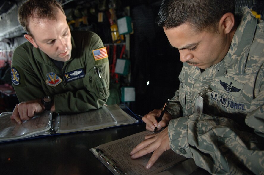 MOODY AIR FORCE BASE, Ga. – Tech. Sgt. Jason McCawley and Master Sgt. Raymond Gallegos, 71st Rescue Squadron loadmasters, verify weight and balance computations prior to a maritime search mission March 26. Rescue operations such as this one require a large amount of heavy equipment. A loadmaster’s job is to ensure it is properly documented, positioned and secured for a safe flight.(U.S. Air Force photo by Tech. Sgt. Parker Gyokeres)