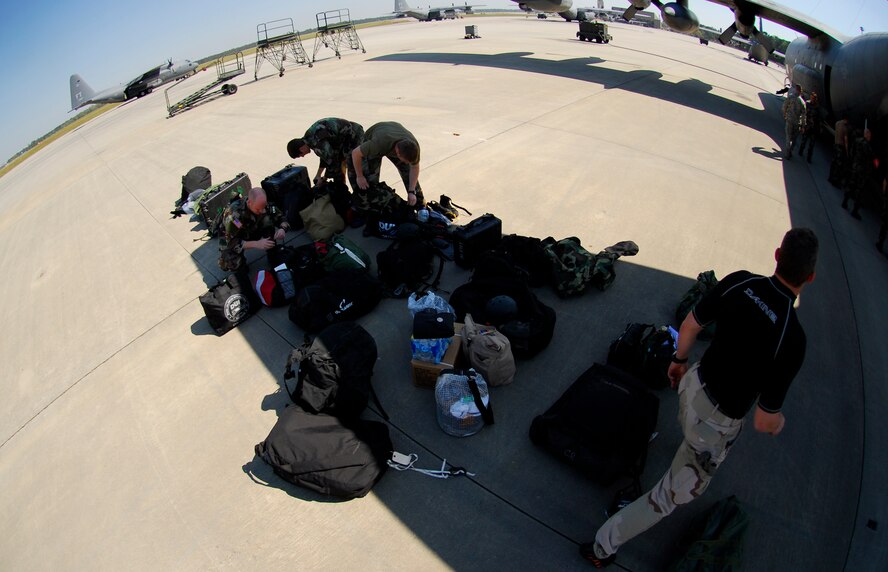 MOODY AIR FORCE BASE, Ga. – Pararescuemen with the 38th Rescue Squadron inspect their personal gear prior to a maritime search and rescue mission on a 71st Rescue Squadron HC-130P March 26. The units were tasked to assist in the search of a missing sailboat in the Gulf of Mexico. (U.S. Air Force photo by Tech. Sgt. Parker Gyokeres)