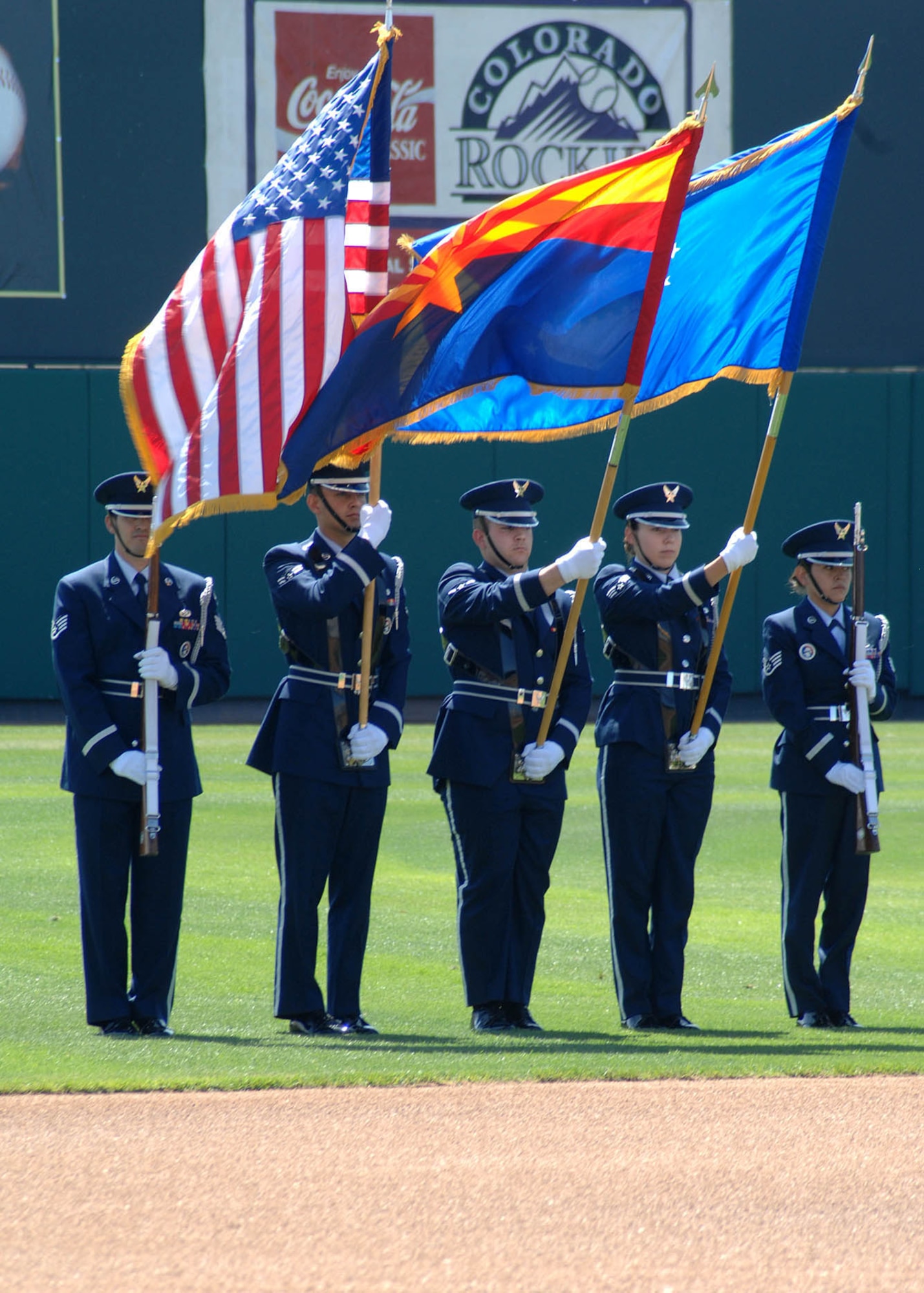 Members of the Davis-Monthan Honor Guard team perfrom colors at Hi Corbett Field March 26. After the posting of colors, members from D-M watched a preseason baseball game between the defending American League Champion Colorado Rockies and the Arizona Diamondbacks. (U.S. Air Force photo by Senior Airman Jacqueline Hawkins)