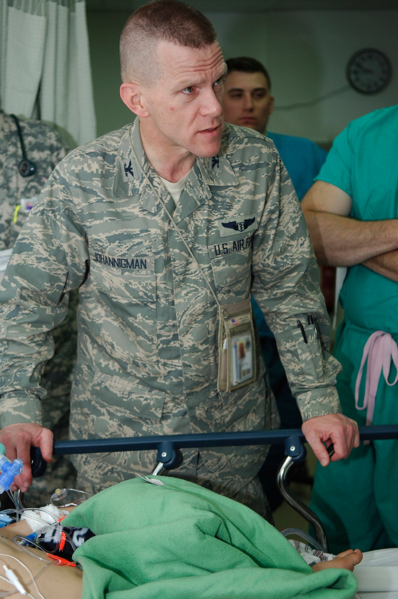 Col. (Dr.) Jay Johannigman listens to a doctor reporting the status of a pediatric gunshot wound victim at Balad Air Base, Iraq, during rounds in the intensive care unit at the Air Force Theater Hospital March 27. As the trauma czar, Colonel Johannigman is responsible for the care of all patients in the intensive care unit and intensive care ward. Colonel Johannigman is assigned to the 332nd Expeditionary Medical Operations Squadron and deployed from Blue Ash Air National Guard Station, Ohio. (U.S. Air Force photo/Staff Sgt. Mareshah Haynes) 
