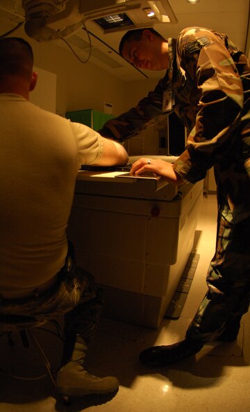 MOODY AIR FORCE BASE, Ga. -- Senior Airman Brian Hermes, 23rd Medical Group diagnostic imaging technician, positions an X-ray tube during training. The Radiology Flight uses fully digital equipment to streamline the patient diagnostic process. (U. S. Air Force photo by Senior Airman Elizabeth Rissmiller)