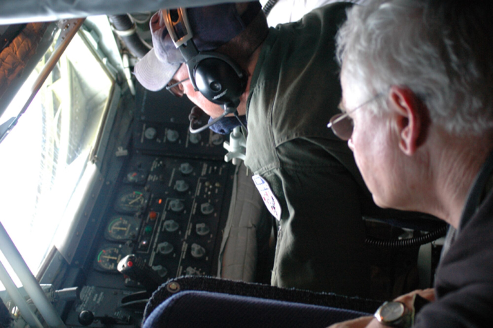 GRISSOM AIR RESERVE BASE, Ind., -- Mike Howard (right) watches aerial refueling operations aboard a KC-135R Stratotanker during a flight from Naval Station Mayport, Fla., to Grissom ARB.  During the flight, a C-130 gunship was refueled by the KC-135.  Howard was one of 29 civic leaders who participated in a special two-day trip to Patrick AFB and Naval Station Mayport.  (U.S. Air Force photo/Senior Airman Carl Berry)