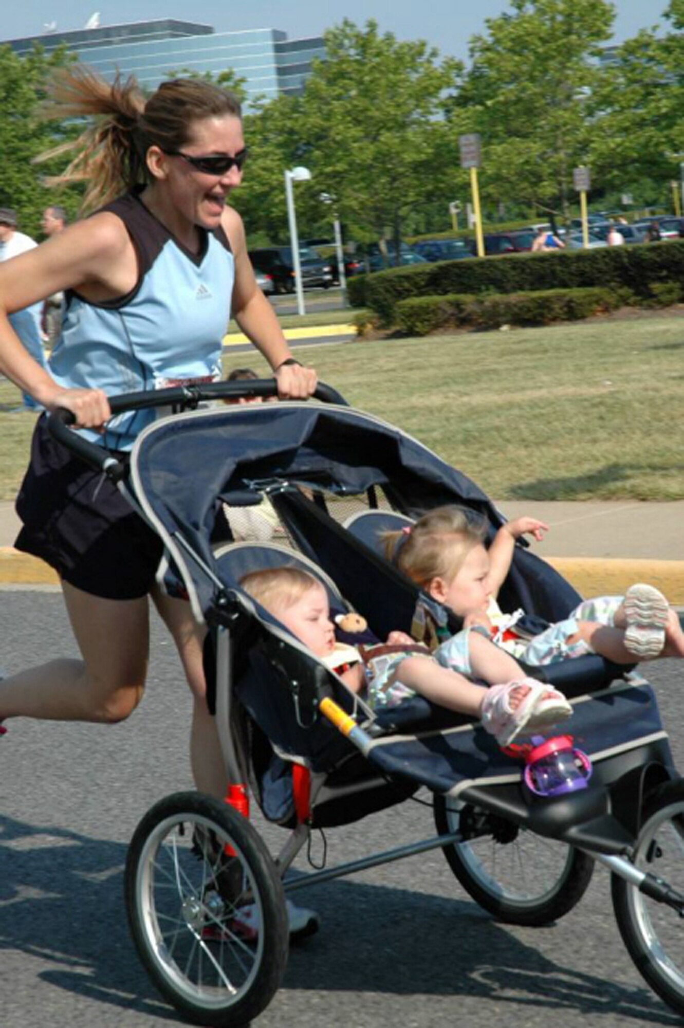 At the summer 2006 Tim Harmon 5K, in Fairfax, Va., Senior Master Sgt. Jennifer Burg teamed up with her twin daughters, Maddy and Kaylee, to win the Baby Jogger Division. "As a single active duty mother of twins, training is quite a challenge," she says. "I find unique ways to incorporate them into the training I do during 'girl' time.  They hop in the jogger, cover up with blankets, and find ways to entertain themselves." (Photo courtesy of Senior Master Sgt. Jennifer Burg.)