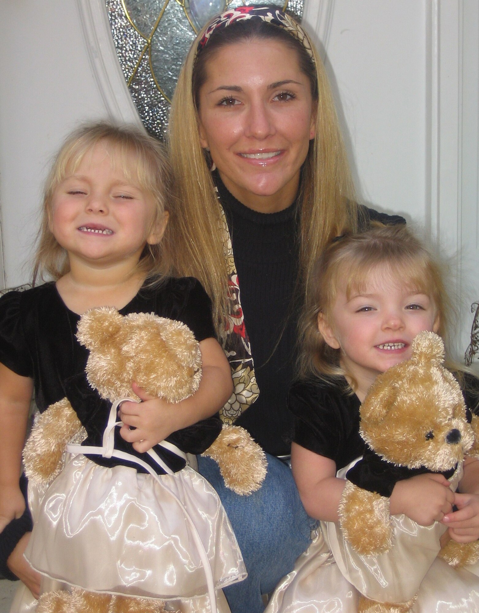 Senior Master Sgt. Jennifer Burg and her 3-year-old twin daughters Maddy, left, and Kaylee, born premature at 31 weeks in January 2005, relax at their Manassas, Va., home. Working closely with the March of Dimes in connection with the pursuit of her first Ironman at the Ford Ironman Louisville (Ky.) Aug. 31, Sergeant Burg has embarked on her own fundraising campaign to help battle birth defects, premature birth and infant mortality. (Photo courtesy of Senior Master Sgt. Jennifer Burg.) 