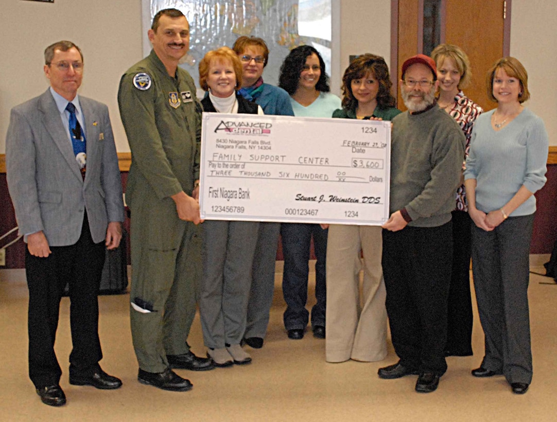NIAGARA FALLS ARS, N.Y. -- Employees from Advanced Dental of Niagara Falls present a check to the 914th Airlift Wing commander, Col. Reinhard Schmidt, and the 914th Family Support Center.  Advanced Dental accomplished a unique fundraiser and donated the proceeds from an entire month's teeth whitening procedures to help support military families.  (U.S. Air Force photo / Mr. Michael Harvey)