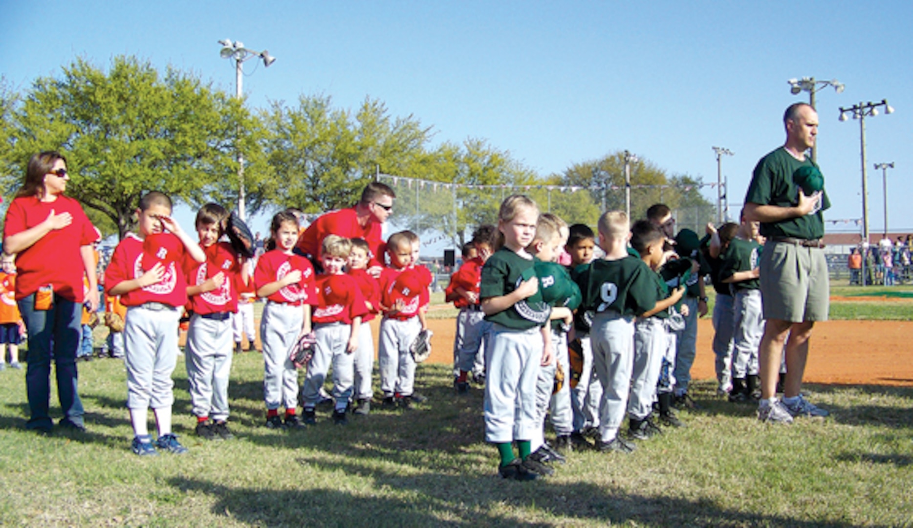 The Randolph Youth Center opened its spring t-ball, softball and baseball season with the national anthem at Ebbets Field Monday. More than 150 Randolph youth participated in the ceremony. (Photo by Maggie Armstrong)