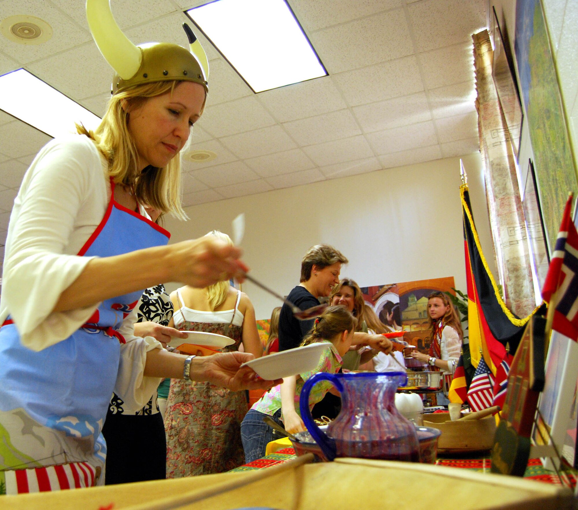 Janelle Simastuen, wife of Norwegian Senior National Representative Lt. Col. Dag Simastuen, serves ricecream and red sauce March 28 at the 2nd Annual Taste of NATO at Sheppard Air Force Base's South Chapel. NATO wives treated the Sheppard Officer's Spouses Club members to authentic European food during the event. (U.S. Air Force photo/John Ingle)