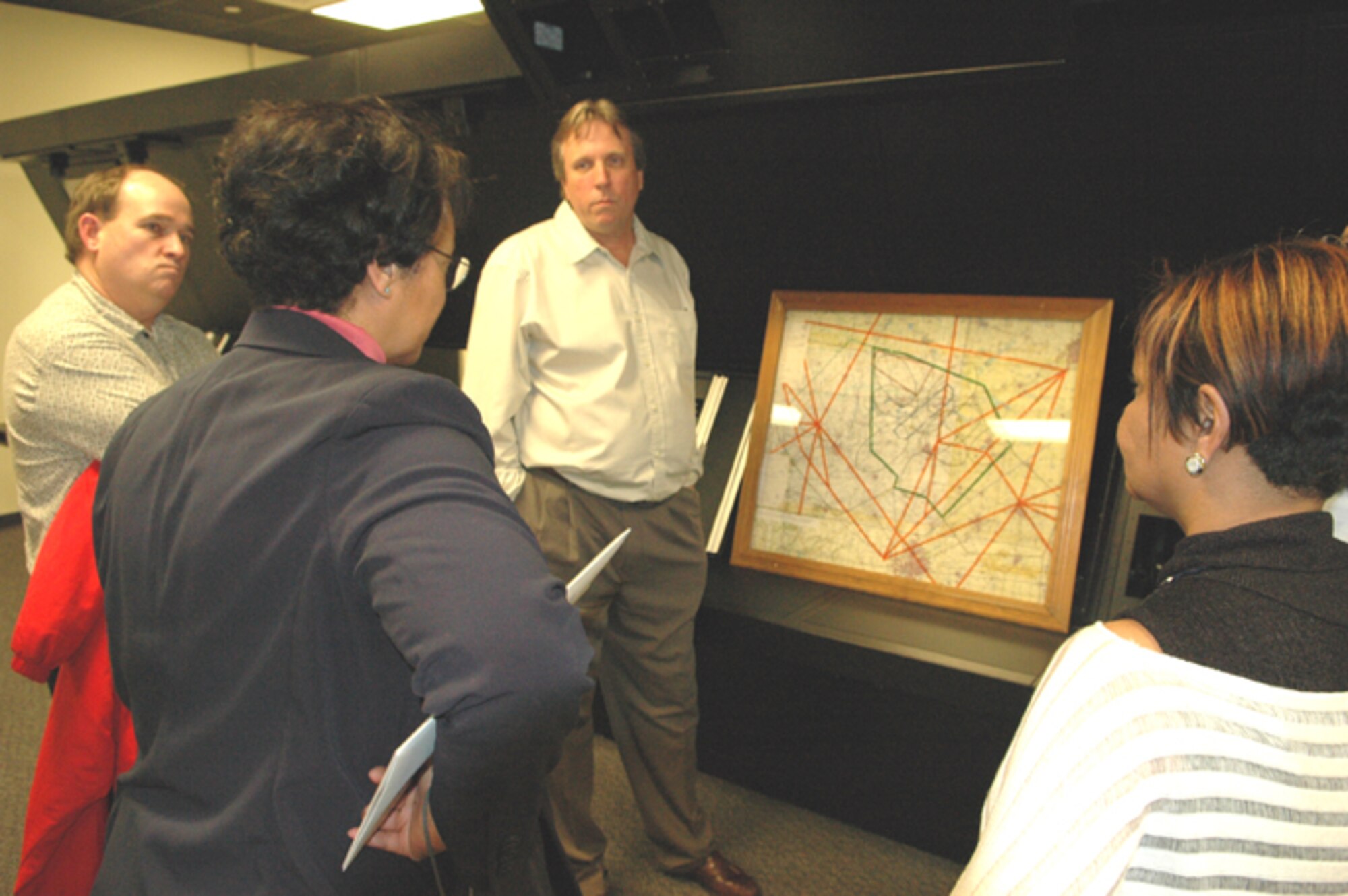 GRISSOM AIR RESERVE BASE, Ind., -- Civic leaders learn about the responsibilities of air traffic controllers at Grissom ARB during a stop at the Radar Approach Control facility. The civic leaders were surprised to learn Grissom's air traffic controllers not only support military aircraft, but any civilian aircraft traveling through North Central Indiana airspace.  (U.S. Air Force photo/Senior Airman Carl Berry)