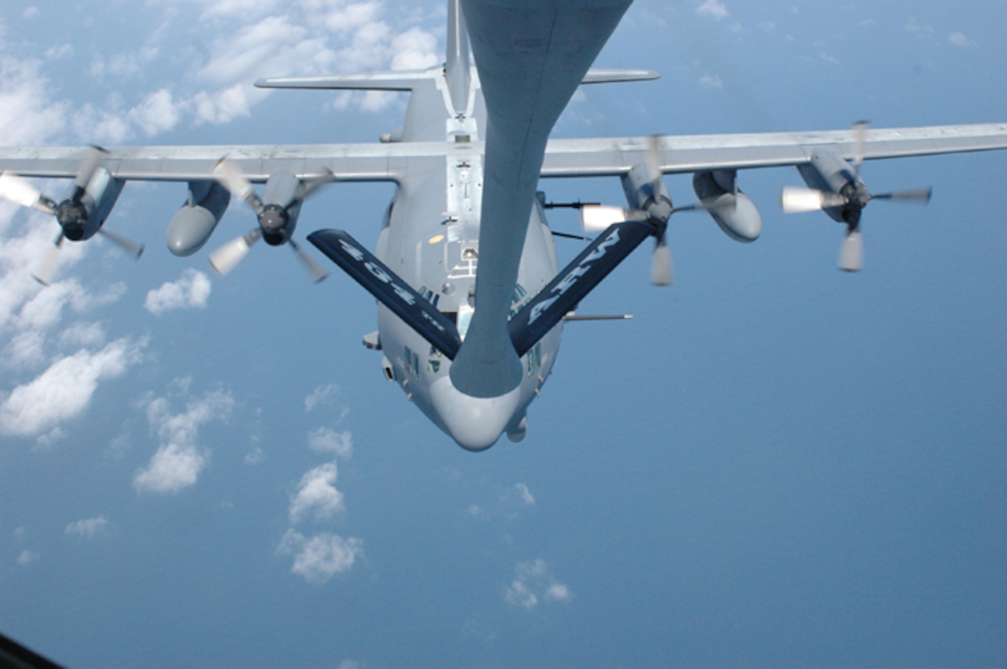 GRISSOM AIR RESERVE BASE, Ind., -- A C-130 gunship pulls into pre-contact position during an aerial refueling mission with a KC-135R Stratotanker from the 434th Air Refueling Wing.  Civic leaders from Indiana who were on board the KC-135R witnessed the mid-air refueling.  (U.S. Air Force photo/Senior Airman Carl Berry)