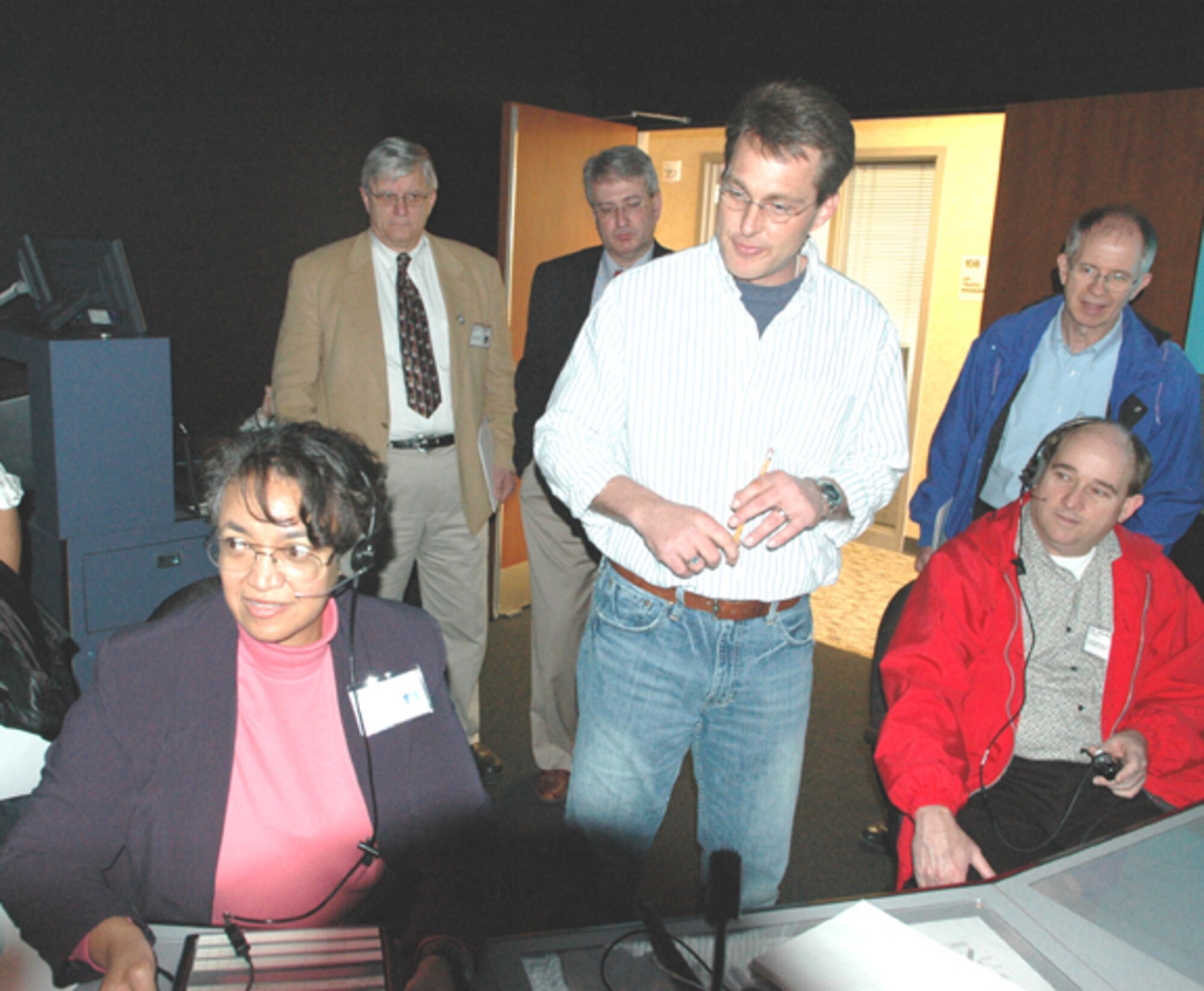 GRISSOM AIR RESERVE BASE, Ind., -- Anita Harden (left) checks out some of the equipment used to train air traffic controllers at Grissom ARB while other civic leaders wait their turn.  The visit to Grissom's new Radar Approach Control facility was just one of the civic leader group activities during the visit to Grissom ARB.  (U.S. Air Force photo/Senior Airman Carl Berry)