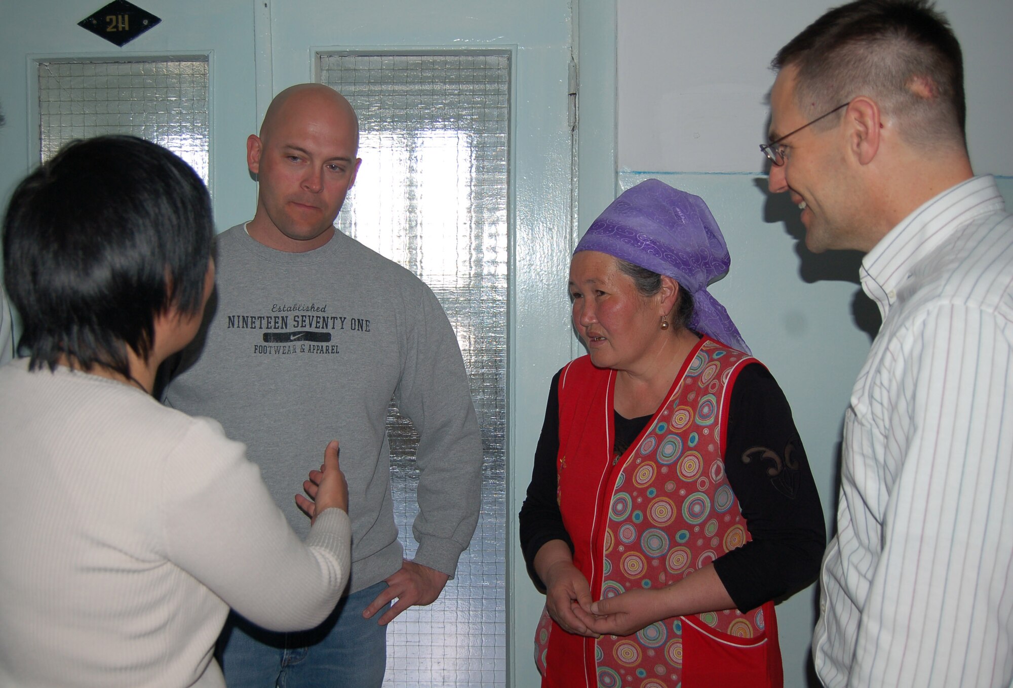 The 376th Aircraft Maintenance Squadron KC-135 Section Chief, Master Sgt. Scott Kaulig talks with Ms. Sakin Tumenbaeva, the mother of the 100th heart surgery patient, Alymbekov Amanbek, through Aigul Karymshakova, 376th Air Expeditionary Wing interpreter, Saturday in the Children's Heart Ward. Airmen from Manas Air Base Outreach Society visited the Children's Heart Ward to celebrate the 100th heart surgery and meet the staff and patients.  (Air Force photo by Tech. Sgt. Jerome Baysmore) 
