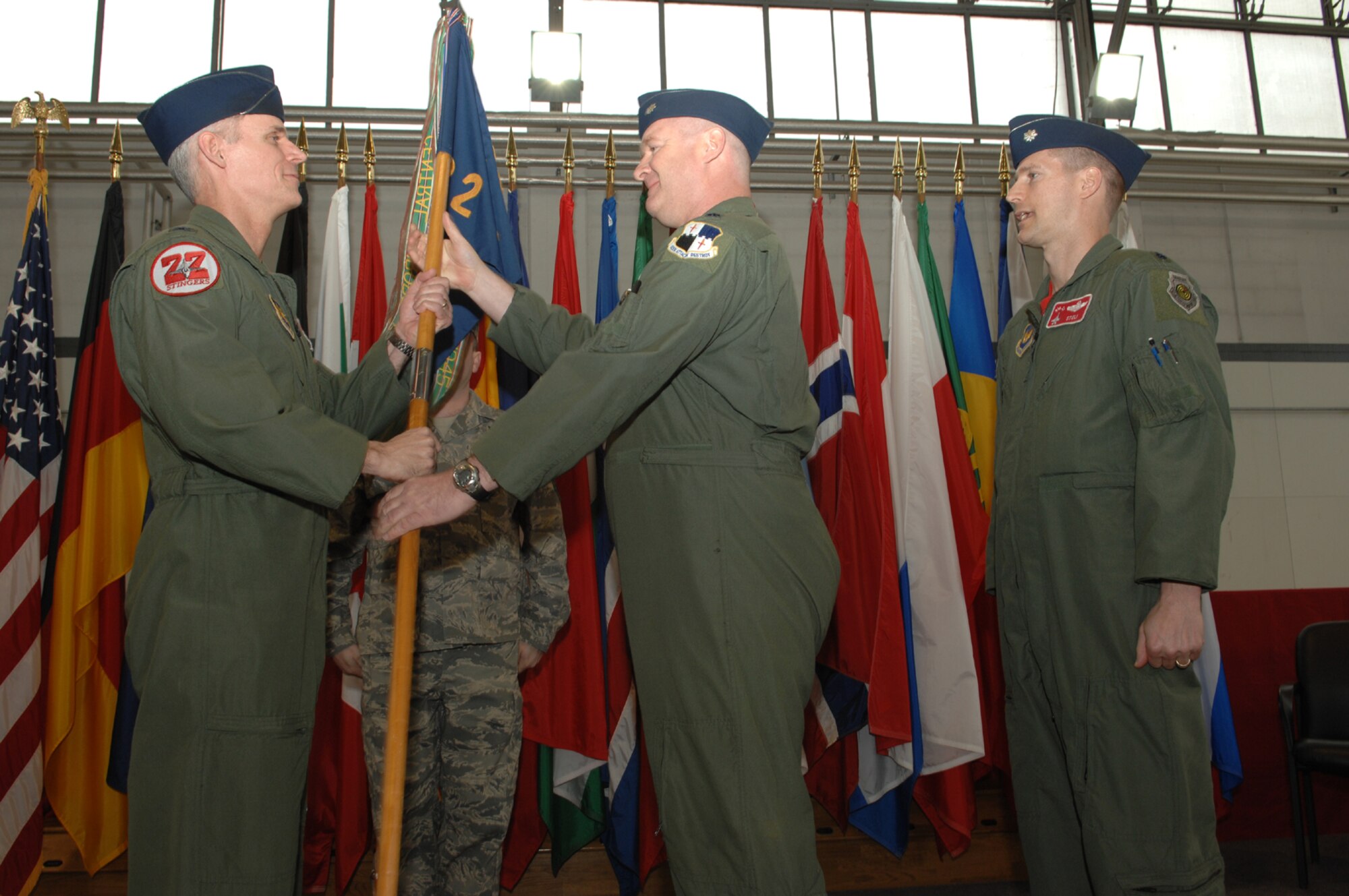 SPANGDAHLEM AIR BASE, Germany – Col. Thomas Lawhead, 52nd Operations Group commander, hands the 22nd Fighter Squadron flag to Lt. Col. Matt Chesnutt, former 22nd Fighter Squadron commander, so it can be relinquished the new commander, Lt. Col. Douglas Nikolai. Colonel Chesnutt became the deputy commander of the 52nd Operations Group. (U.S. Air Force photo/Senior Airman Logan Tuttle)
