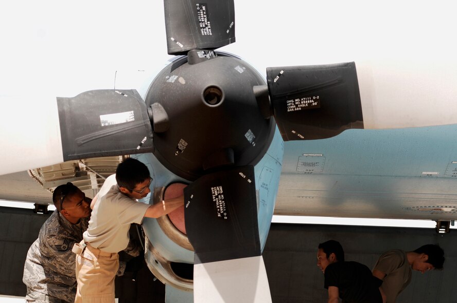 SOUTHWEST ASIA -- Maintainers from the Japan Air Self-Defense Force Iraq Reconstruction Support Airlift Wing and Staff Sgt. Ray Pontemayor (left), a maintainer deployed to the 386th Expeditionary Aircraft Maintenance Squadron, inspect a JASDF C-130 Hercules March 21, 2008, at an air base in the Persian Gulf Region. Airmen from the U.S., JASDF, and Republic of Korea Air Force 58th Airlift Wing participated in a coalition maintenance exchange program allowing maintainers to sharpen their skills, exchange ideas, and promote closer relations among coalition air forces supporting the Global War on Terrorism. (U.S. Air Force photo/ Staff Sgt. Patrick Dixon) 