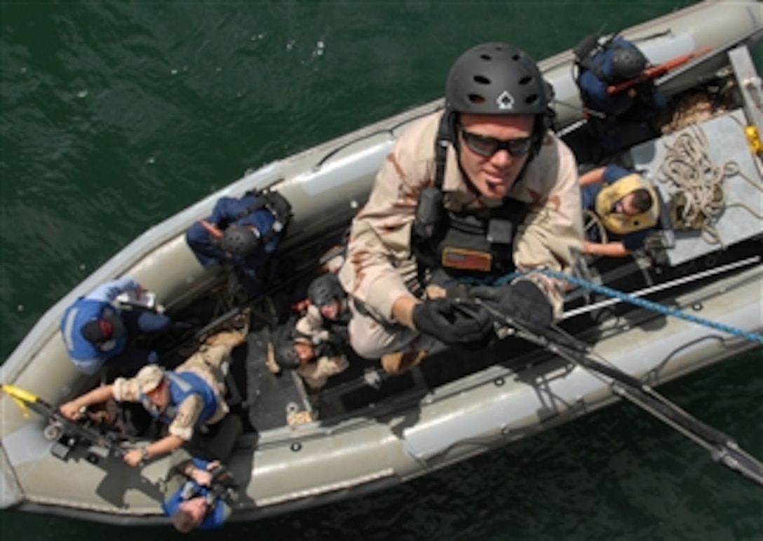 U.S. Navy Lt. j.g. Lawrence Heyworth climbs a ladder during a boarding drill on the decommissioned ship USS Duluth (LPD 6) in Pearl Harbor, Hawaii, on March 26, 2008.  Heyworth and his visit, board, search, and seizure team of the Pearl Harbor-based guided-missile destroyer USS Chung-Hoon (DDG 93) are training in boarding procedures and tactics in preparation for an upcoming deployment.  