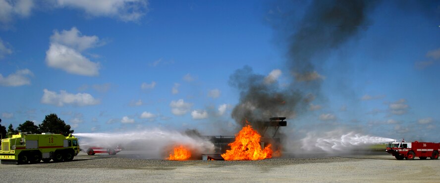 MOODY AIR FORCE BASE, Ga. -- Aircraft crash response fire trucks from the 23rd Civil Engineering Squadron Emergency Services Flight arrive onto the scene of a training exercise at Moody's aircraft burn pit April 25.  The facility was recently brought back into operation after more than a year of repairs by the base's civil engineers.  (U.S. Air Force photo by Tech. Sgt. Parker Gyokeres) 