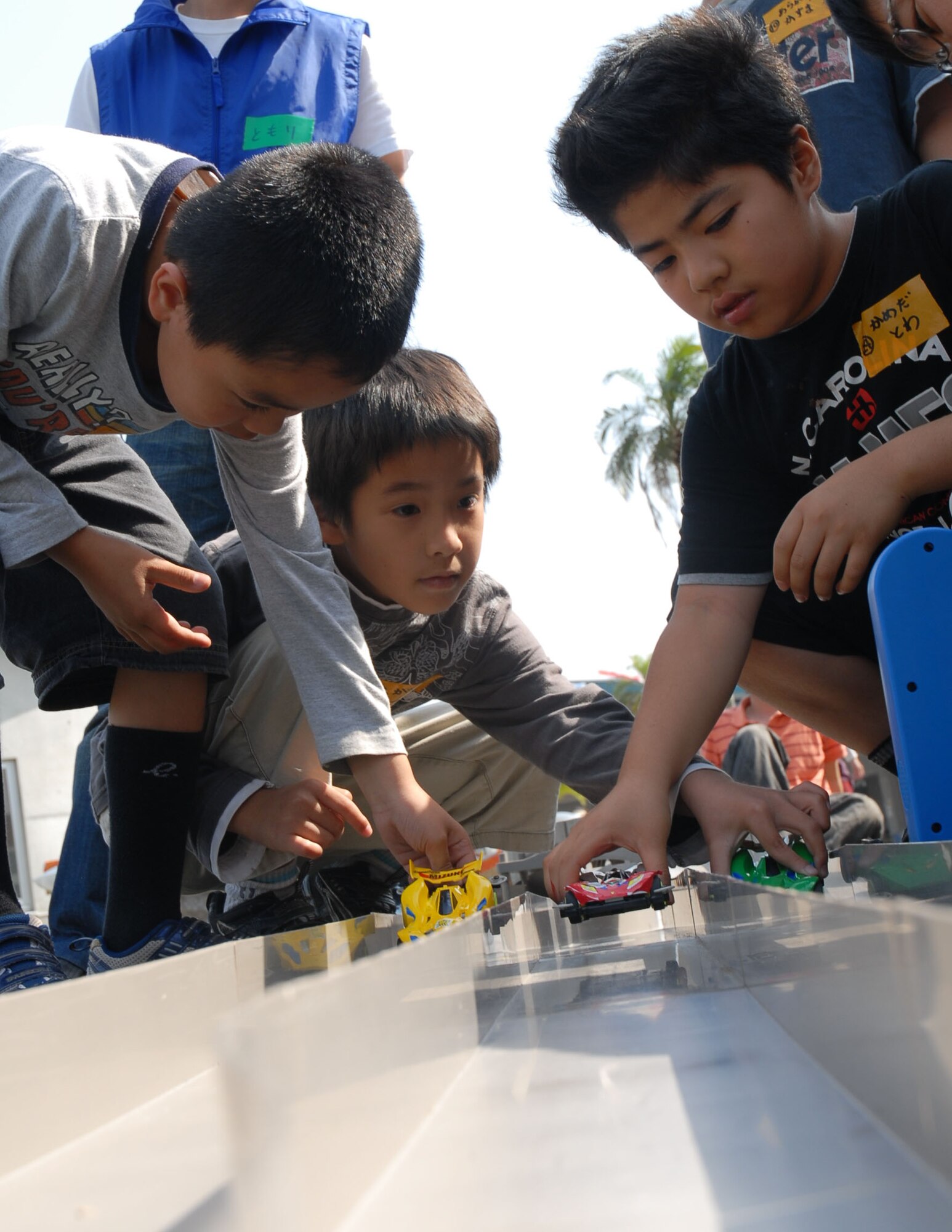 Participants position their cars at the starting line after building them in a workshop at the Okinawa City Children’s Zoo April 27. More than 50 American and Okinawan children took part in the building and racing of the battery-operated cars. (U.S. Air Force photo/Airman Chad Warren)