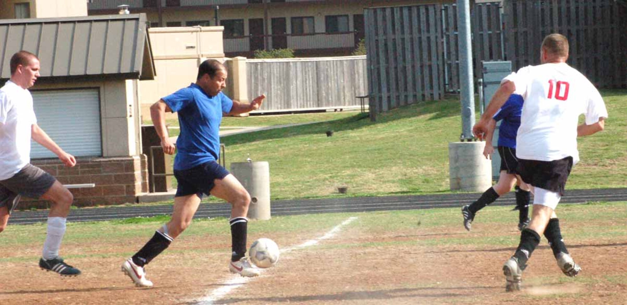 Mostafa Maiz , 38th Engineering Group forward, dribbles the ball through midfield as SPIRIT defender (10) Aaron Byard tries to steal it. The April 24 match ended in a 3-3 tie.  (Air Force photo by Margo Wright)