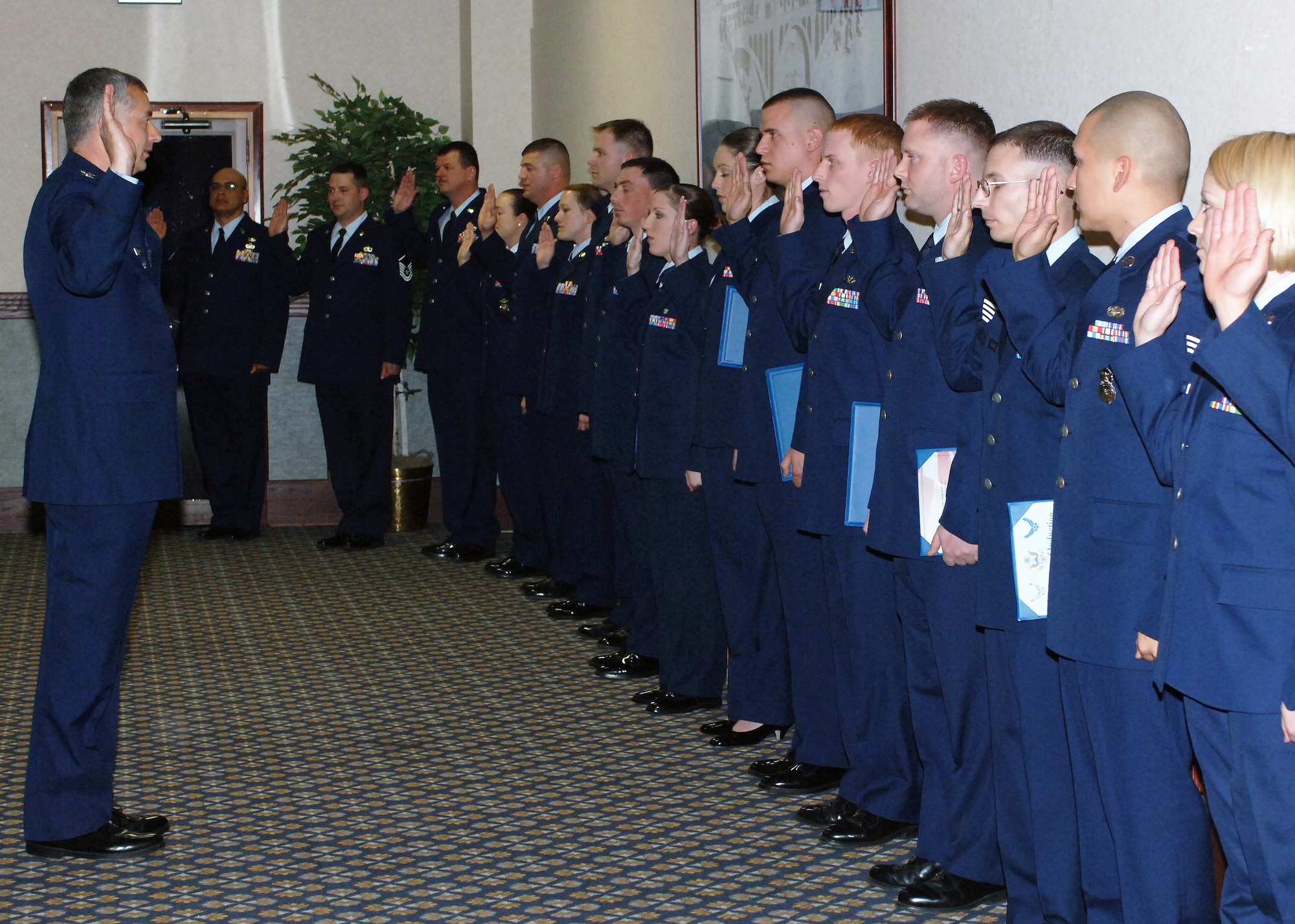 FAIRCHILD AIR FORCE BASE, Wash. – Col. Roger Watkins, 92nd Air Refueling Wing acting commander, swears in Airmen recognized at the Wing Promotion Ceremony April 30 at Club Fairchild. (U.S. Air Force photo / Airman 1st Class Melissa Barnett)