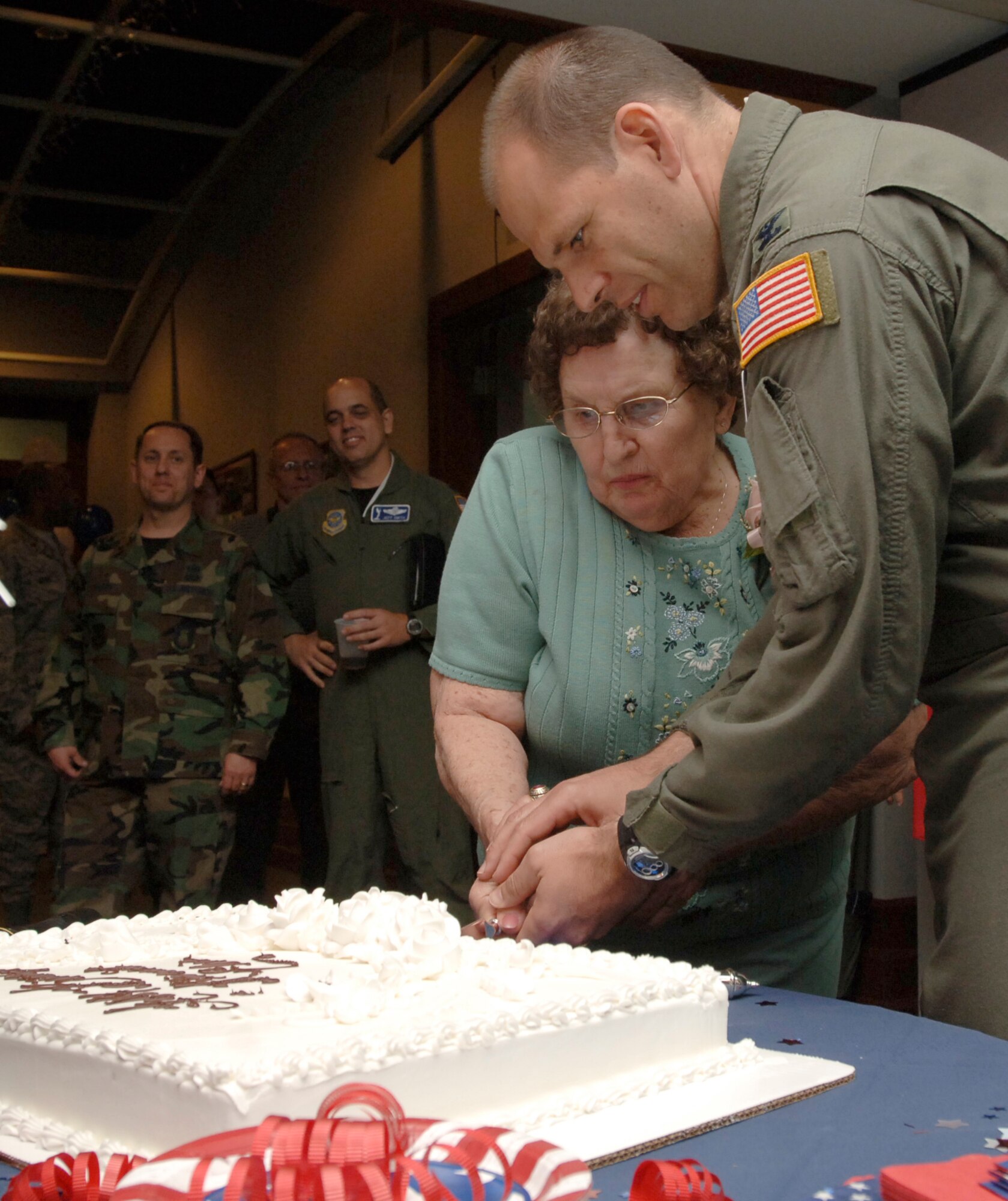 MCCONNELL AIR FORCE BASE, Kan. -- Elsie Fullerton and Col. James Vechery, 22nd Air Refueling Wing commander, cut Elsie’s birthday cake at the Officer’s Club, April 25. Ms. Fullerton was congratulated not only by active duty Airmen, but also retired military members, the Friends of McConnell, Wagon Masters and several personal friends. (Photo by Senior Airman Roy Lynch III)