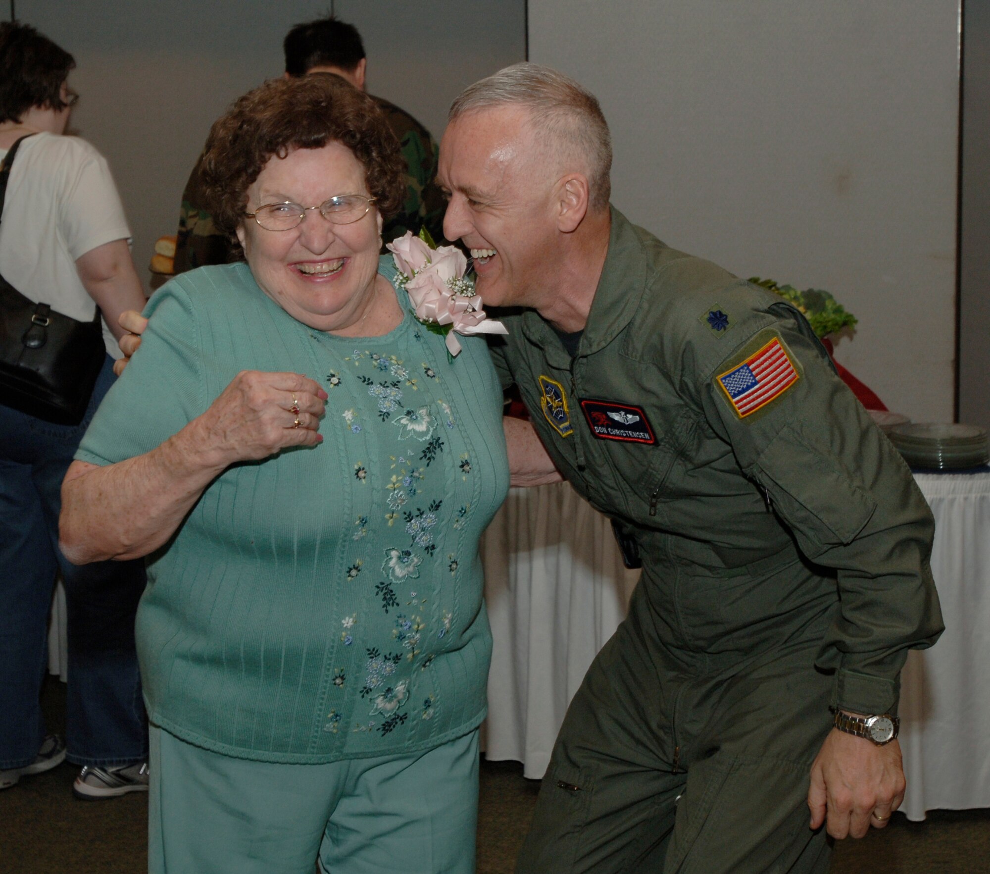 MCCONNELL AIR FORCE BASE, Kan. -- Elsie Fullerton and Lt. Col. Donald Christensen, 22nd Aerospace Medicine Squadron commander, gives into lighthearted silliness during Elsie’s birthday and retirement party at the Officer’s Club, April 25. Ms. Fullerton retired on her 75th birthday after 49 years of service. (Photo by Senior Airman Roy Lynch III)
