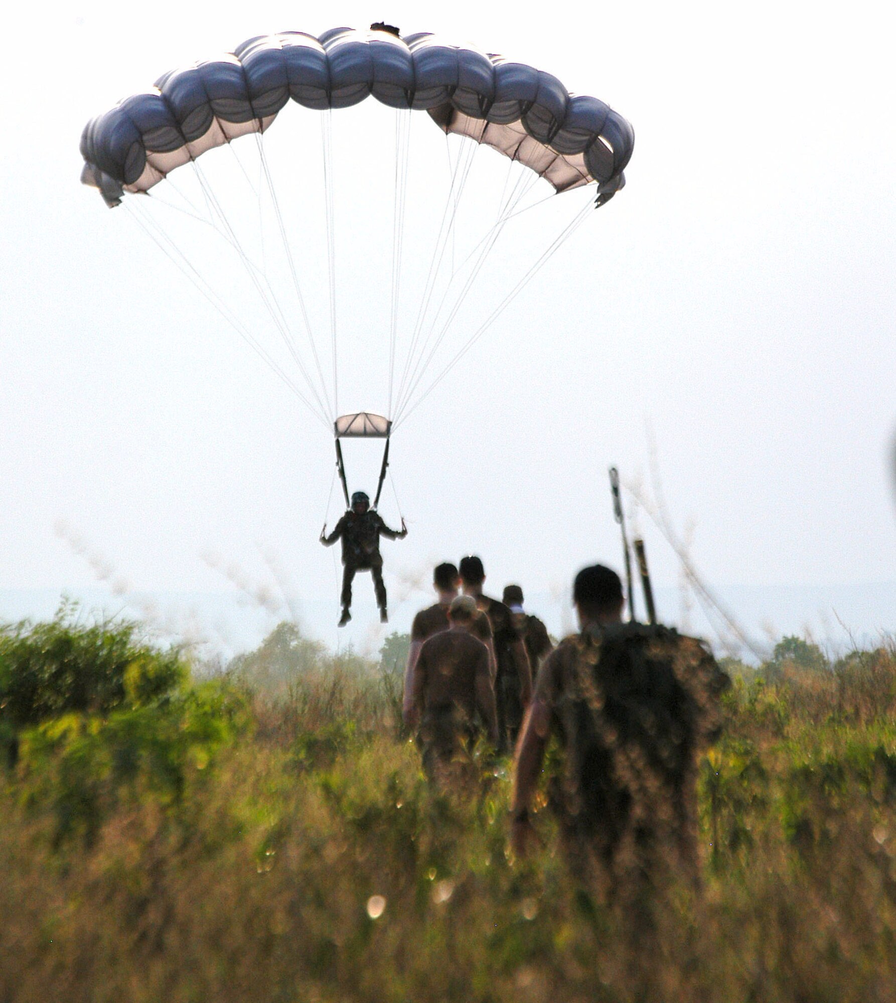 Drop zone controllers head out to recover a jumper from the 320th Special Tactics Squadron during Exercise Teak Torch at Udon Thani, Thailand. Jumpers from both the 353rd Special Operations Group and the Royal Thai air force completed daily "friendship jumps" as part of the joint combined exercise training. (U.S. Air Force photo/Master Sgt. Marilyn Holliday)                            
