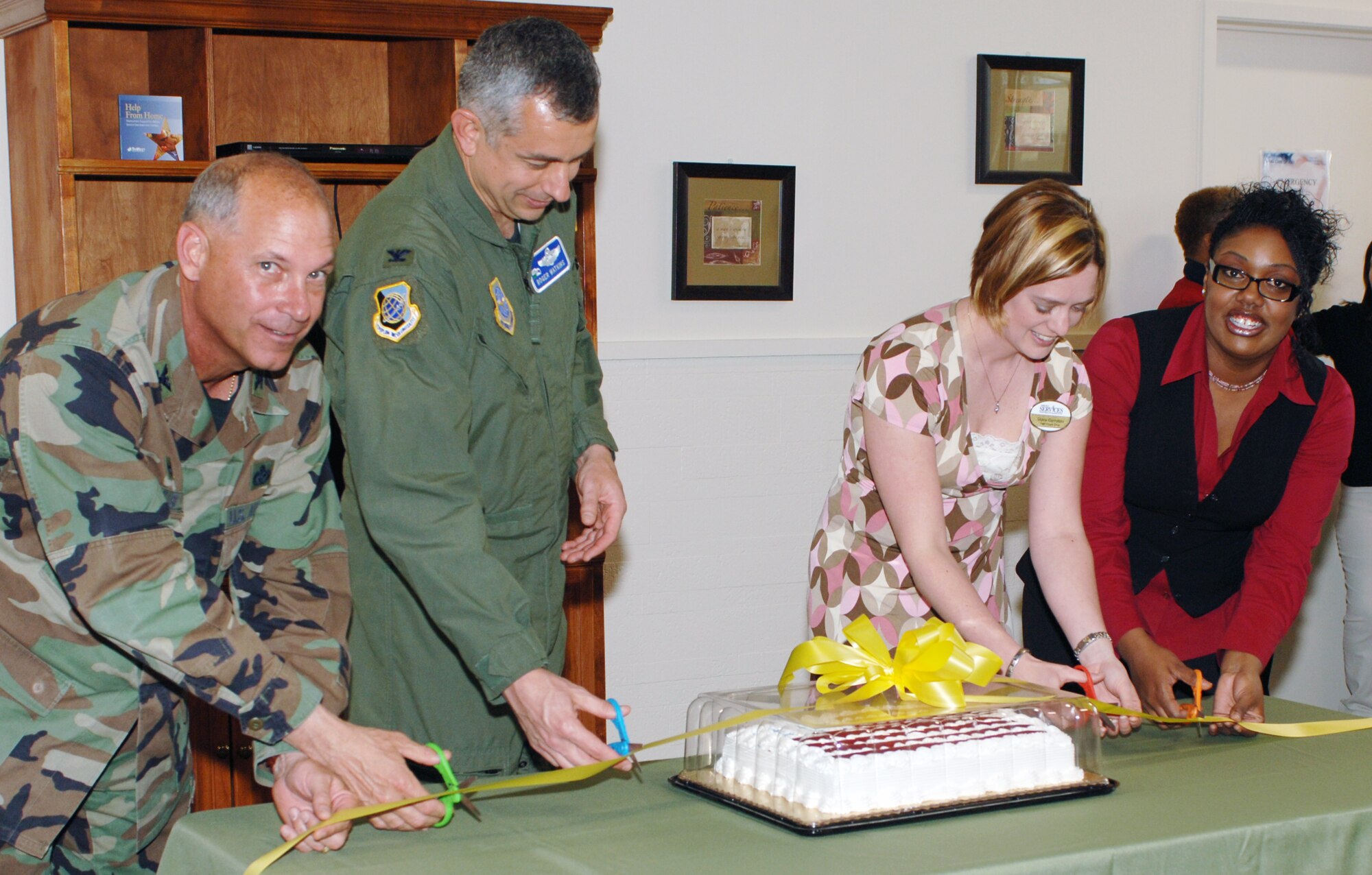 FAIRCHILD AIR FORCE BASE, Wash. – Col. Van Fuller, 92nd Mission Support Group commander; Col. Roger Watkins, 92nd Air Refueling Wing acting commander; Stacy Compton, 92nd Services Squadron family members program flight chief; and Javonika McCree, Airman and Family Readiness Center community readiness technician, cut a ribbon to celebrate the grand opening of the Family Oasis at the Deel Community Center April 29. (U.S. Air Force photo / Airman 1st Class Melissa Barnett)