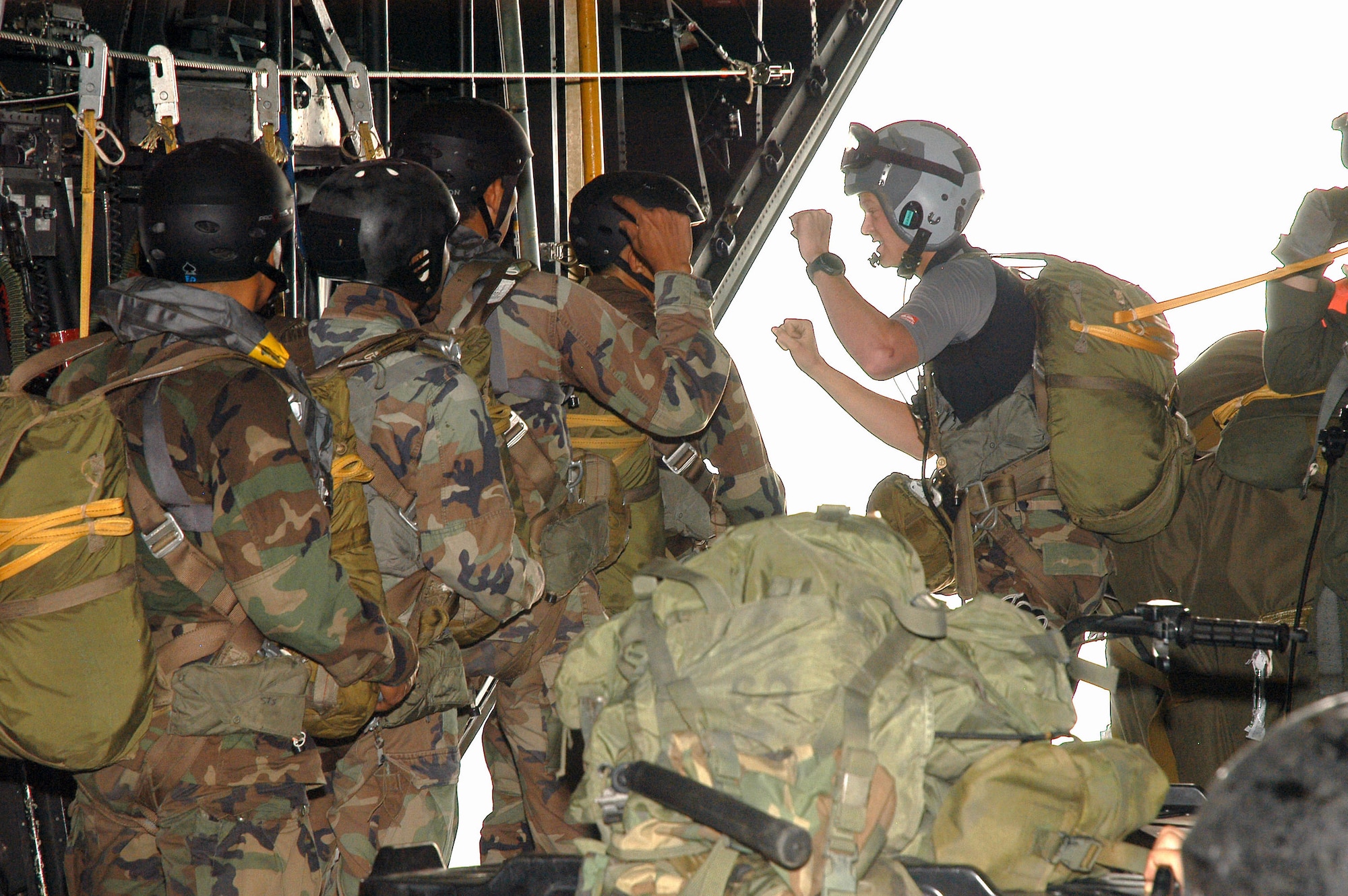 A combat controller from the 320th Special Tactics Squadron (right) gives the final count for a static line jump of Royal Thai air force special forces aboard an MC-130P Combat Shadow. The American and Thai airmen were participating in Exercise Teak Torch at Udon Thani, Thailand. (U.S. Air Force photo/Master Sgt. Marilyn Holliday)             