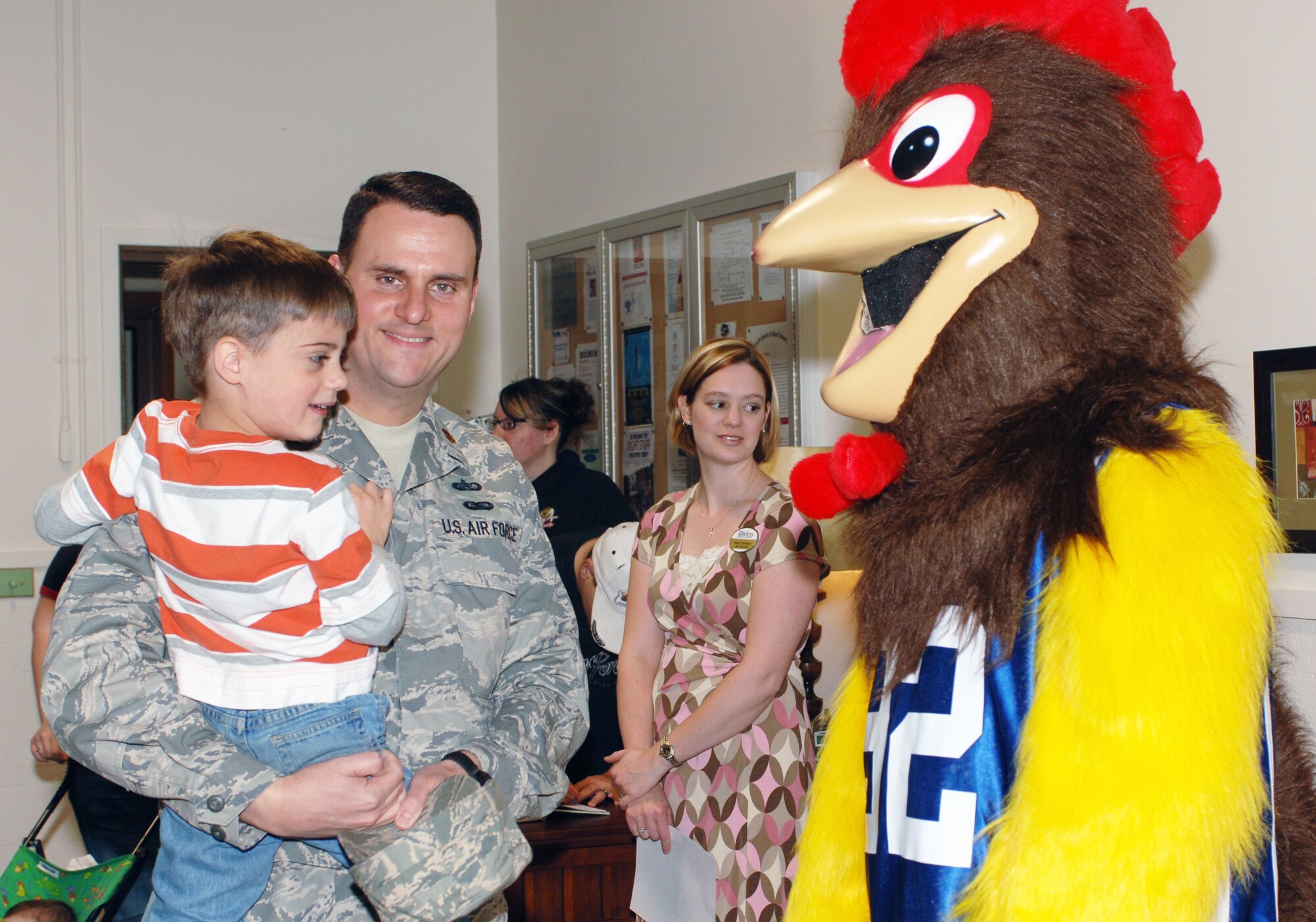 FAIRCHILD AIR FORCE BASE, Wash. – Maj. David Ellison, 92nd Services Squadron commander, and son, John, say hello to Rowdy the Rooster at the grand opening of the Family Oasis at the Deel Community Center April 29. The Family Oasis was envisioned by Lori Sharpy, wife Col. Thomas Sharpy, 92nd Air Refueling Wing commander; Stacy Compton, 92nd SVS family members program flight chief; and Javonika McCree, Airman and Family Readiness Center community readiness technician, as a place where spouses and families can come together and form new, lasting relationships and bonds. (U.S. Air Force photo / Airman 1st Class Melissa Barnett)