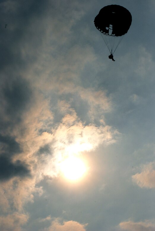 A paratrooper descends through the early morning sky over Soto Cano Air Base, Honduras, during a combined airborne operation with U.S. and Honduran soldiers April 30. The operation was part of an idea exchange with Honduran military members in preparation for a multi-national exercise in August. (U.S. Air Force photo by Tech. Sgt. John Asselin)