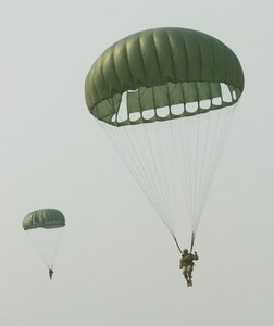 Paratroopers descend over the drop zone at Soto Cano Air Base, Honduras, during a combined airborne operation April 30. The operation was part of a week-long idea exchange between U.S. and Honduran soldiers. (U.S. Air Force photo by Tech. Sgt. John Asselin)