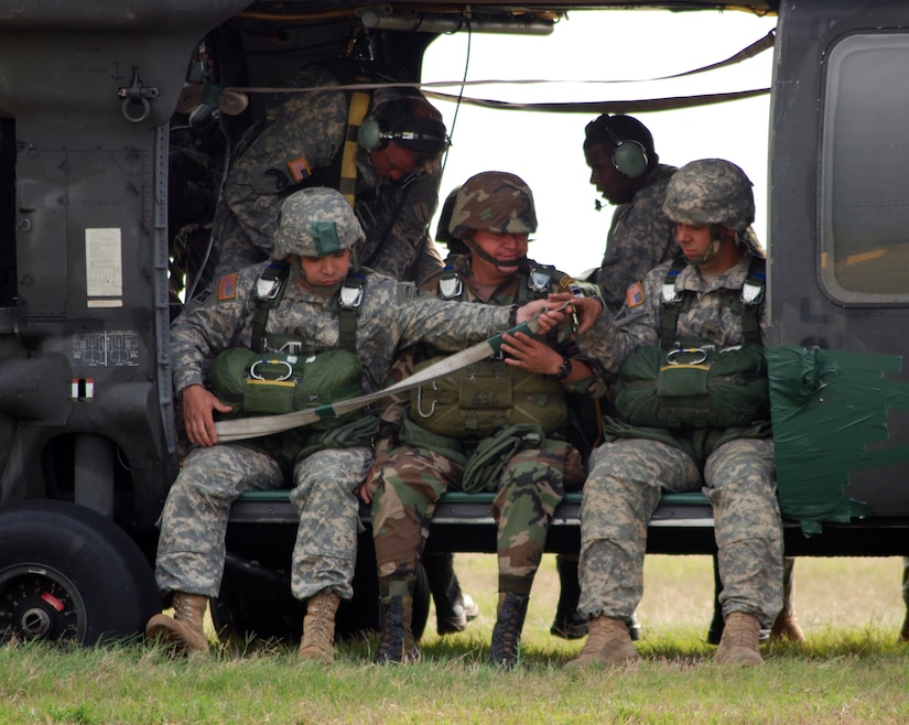 U.S. and Honduran soldiers strap into a Joint Task Force-Bravo UH-60 Blackhawk during a combined airborne operation April 30. Troops from the 509th Airborne Battalion were at Soto Cano Air Base, Honduras, as part of a week-long Key Leader Exchange program. (U.S. Air Force photo by Tech. Sgt. John Asselin) 