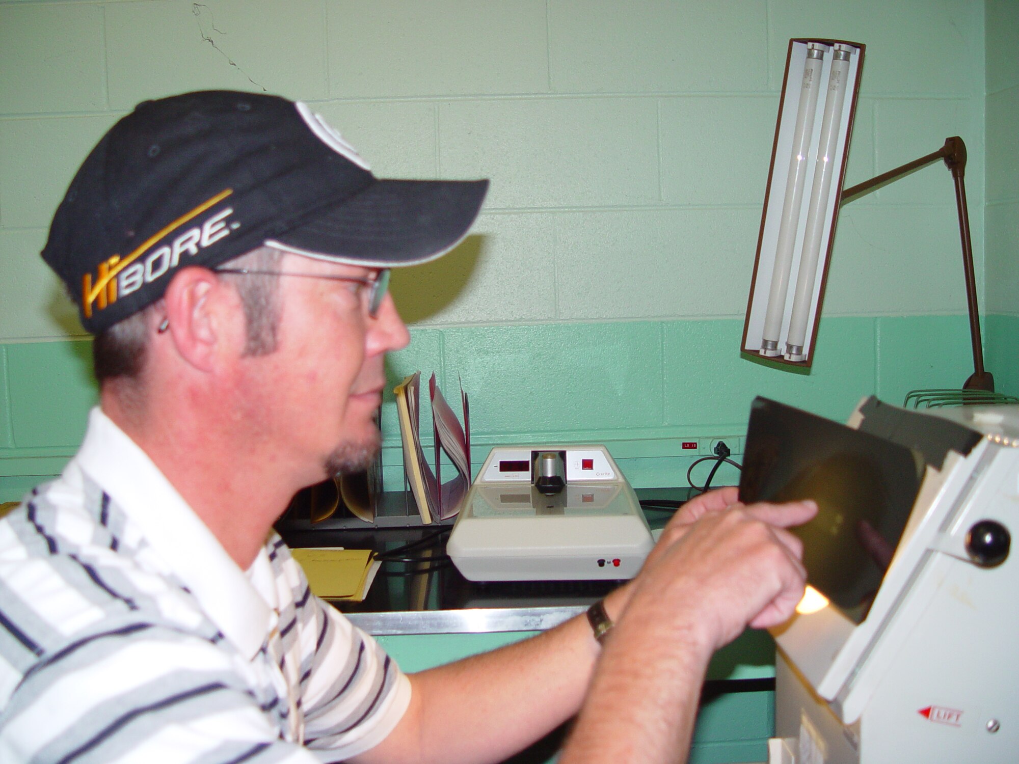 Steve Medley is reviewing a radiograph that was taken on a pipe weld in the X-Ray Lab at Arnold Engineering Development Center, Arnold Air Force Base, Tenn. (Photo by Janae' Daniels)