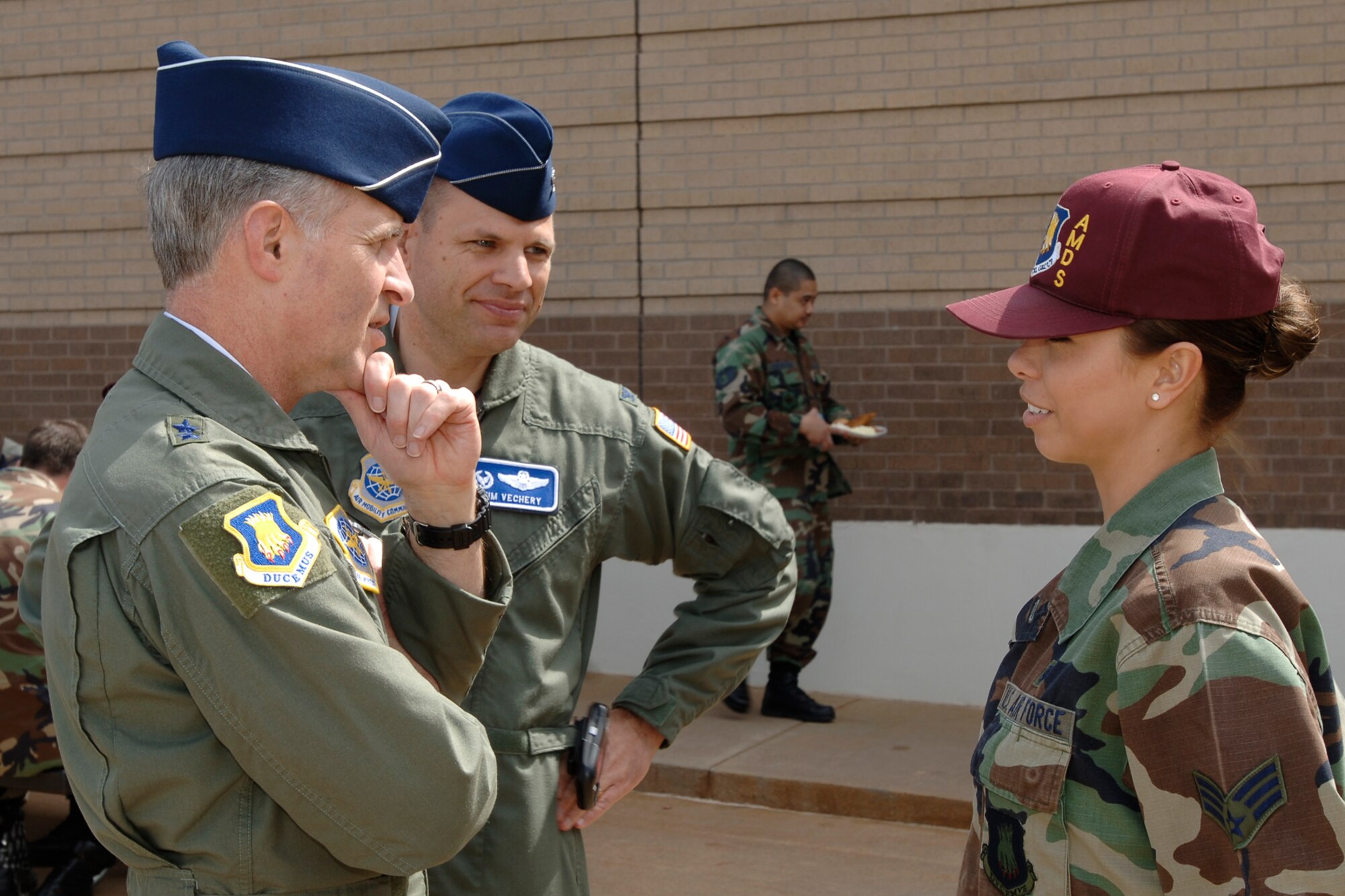 MCCONNELL AIR FORCE BASE, Kan. -- Senior Airman Robyn Matthews, 22nd Aerospace Medicine Squadron, talks with Maj. Gen. James Hawkins, 18th Air Force commander, during a chapel chow down here at McConnell AFB, April 30. The chapel chow down was held by the base chapel for the medical group to promote the services they offer to the base.  (Photo by Senior Airman Jamie Train)